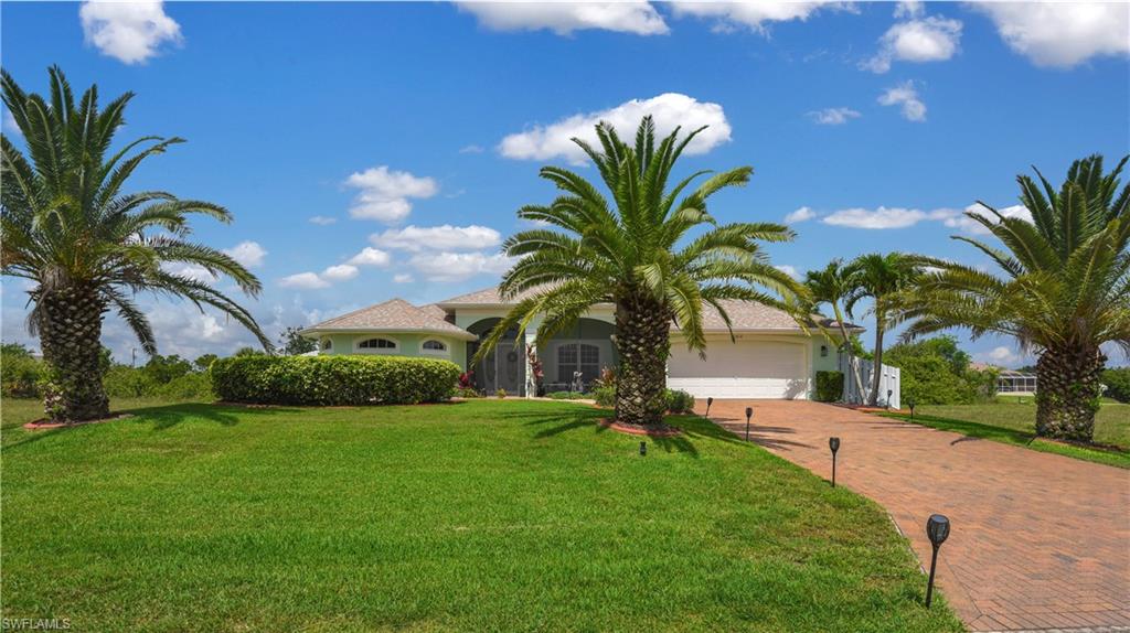 METICULOUSLY CARED FOR single family pool home on freshwater canal! This home is just like BRAND NEW - gently lived in, well taken care of, & offers more BELLS & WHISTLES than most... solar panels making the home energy efficient, Manoblock water control system, large tile flooring throughout, pavers (on driveway, walkways, front lanai, & pool lanai), French doors on front screened-in lanai & at entry of home, cathedral ceilings, classic living & family room layout, custom trim, spacious kitchen w/ breakfast bar & breakfast nook, massive rear pool lanai w/ under truss sitting area & half bath, and a private boat dock. You can spend hours fishing in the freshwater canals & lakes that Cape Coral has to offer. Surrounded by custom built single family homes and having easy access to Fort Myers & I-75, plus close to schools, shopping centers, & restaurants. Only 20 minutes away from the island life of Pine Island & Matlacha w/ art boutiques & restaurants, 13 miles from the shopping & dining of Cape Harbour, and just 8 miles away from the redeveloped River District of Fort Myers.
