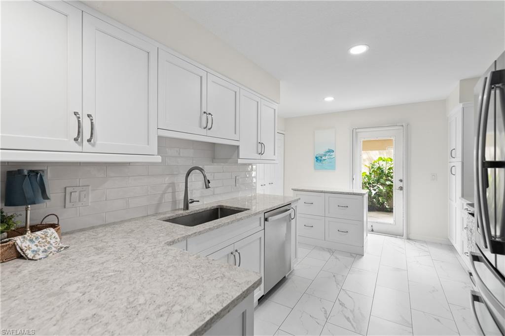 RARELY AVAILABLE FIRST-FLOOR END UNIT WITH GARAGE — NO STAIRS, REASONABLE FEES, AND BEAUTIFUL UPDATES THROUGHOUT! This spacious 2-bedroom + den, 2-bath condo offers the perfect blend of comfort, privacy, and convenience in the gated community of Bermuda Park. Featuring a great room and split bedroom floor plan, breakfast bar, screened lanai with lush tropical privacy, and a private courtyard-style patio between the kitchen and garage, this home lives like a peaceful retreat. The beautifully renovated kitchen is the centerpiece of the home and includes white soft-close cabinetry and drawers, a built-in pantry with pull-out shelving, quartz countertops, under-mount stainless steel sink, white subway tile backsplash, rectangular tile flooring, a center island with oversized drawers, and GE Profile stainless steel appliances (2025). Additional updates include a Samsung washer (2022), luxury vinyl plank flooring throughout the great room, bedrooms, and den, fresh interior paint in the den (May 2026), and a new AC system (2026). ***The den/office has a closet and window so can be used as a third bedroom. Major community improvements have already been completed, including all new roofs in 2025 and exterior painting in 2026.
Ideally located close to the Bermuda Park pool and just a short stroll to the shared Villages of Bonita amenities, residents enjoy access to a community room, spa, tennis courts, pickleball, shuffleboard and an active social calendar. Conveniently situated off Old 41, Bermuda Park is minutes from Coconut Point Mall, Bonita Beach, Barefoot Beach, Ft. Myers and Naples Beaches, Gulf Coast Town Center, Miromar Outlets, RSW International Airport, Mercato, and countless dining destinations—perfectly positioned between Naples and Fort Myers. You’re also less than 5 minutes from the vibrant Downtown Bonita Springs district, known for its charming atmosphere, Riverside Park, festivals, live music, artisan shops, unique dining, and riverfront recreation. With quarterly fees of just $2,481, this is an exceptional opportunity to enjoy updated, low-maintenance living in one of Bonita Springs’ most convenient and desirable locations.