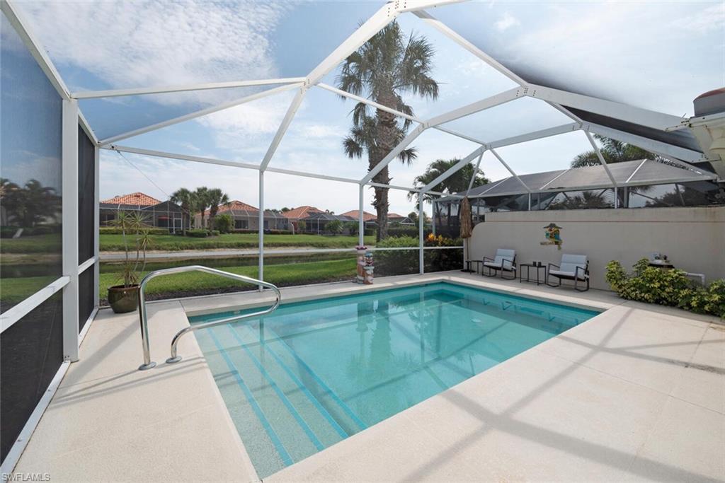 This move-in-ready professionally beach themed decorated Capri model pool home is offered turnkey. The kitchen is lovely with a granite extended breakfast bar that allows the kitchen and living areas to be open and interactive. It also has stainless steel appliances with a newer dishwasher and microwave. Natural ambient lighting, high ceilings and tranquil views of the pool and lake from the kitchen and living areas. The primary suite overlooks the lake and offers a large walk-in closet. The shower in the primary bath has been remodeled with updated tile and a seamless glass door. The guest bedroom has two queen-sized beds and a walk-in closet. Both bedrooms have wood-look vinyl flooring. Relax on the screened lanai overlooking the pool and the tranquil lake. Inside the open concept allows space for gathering with family and friends or just to spread out. No need to worry about storms. This home has a newer tile roof installed in 2019, electric shutter on the lanai and attached accordion manual shutters on the windows. Located in North Naples, the 24-hour guard-gated community of Village Walk is a short drive to the beach. Beautifully landscaped with miles of paved walking paths around lakes. Enjoy carefree living with a wealth of resort-style amenities, including the town center, indoor/outdoor on-site dining, fitness area, saltwater resort-style pool and lap pool, tennis, social/club room, bocce, post office and beauty salon. Minutes to shopping, dining, grocery stores, schools, and medical facilities.