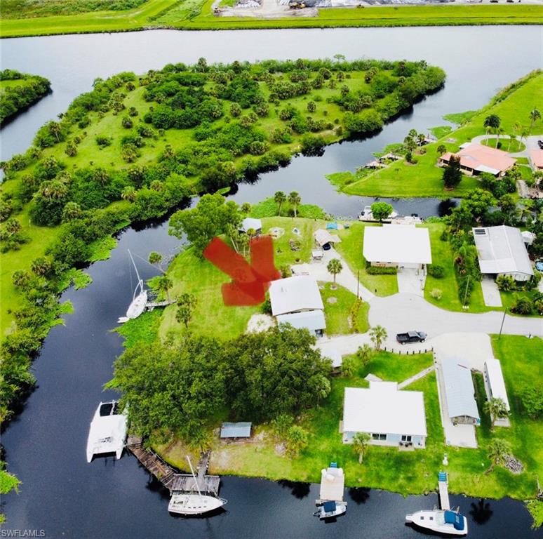 MOTIVATED SELLER!!!!!..Come one Come all this home has it all!!! Located in the popular Turkey Creek boating Community in Ortona, this cute and cozy CBS home is situated on 3 lots with breathtaking views of the water. This water-front property has deep water access to the Atlantic Ocean, Lake Okeechobee, and the Gulf of Mexico. The locks are located about a half of a mile from here allowing for a quick trip to catch big snook!! For all of you men and women that love to piddle there is a 12 x 18 enclosed work shop building including electric and a carport attached. There is also a 12 x 28 pole barn which makes for a perfect spot for your RV and includes septic, water, and electrical hook up. One of my personal favorites is the tall gazebo which is lit up beautifully at night and has plenty of room for hanging out with friends and family while watching the yachts go by or the family of manatees swimming with their babies!