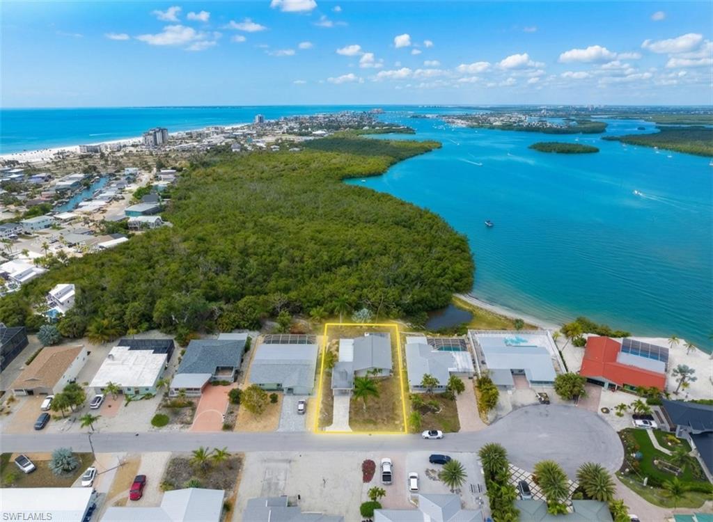 $25,000 REDUCTION! Prime investment opportunity in Fort Myers Beach. Situated on a .18-acre lot with bay views and just a short walk to the beach, this property offers strong redevelopment and income potential in a high-demand market. This lot looks over 45 acres of vacant land & Fort Myers Beach Bay, offering ultimate privacy! The existing 2-bedroom, 1-bath home features an open living area, two patio spaces, and a carport - providing the option to renovate. Whether repositioned as a seasonal rental, short-term vacation property, or new construction project, this location supports strong demand from both vacationers and second-home buyers. Opportunities to secure a bay-view lot within walking distance to the beach are increasingly limited - making this a strategic acquisition for investors focused on appreciation and income potential. Don't miss this opportunity, schedule your tour today!