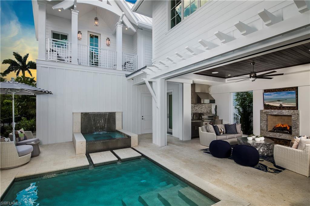 STOCK CUSTOM HOMES and MHK bring its superior quality of custom craftsmanship to Olde Naples with the Residences On Sixth-a coastal contemporary look featuring a layered neutral color palette that is light, airy, and consistent. Designed for indoor- outdoor living. Features Include: Master suite on first floor with private laundry, Cabana bedroom with private entrance, three car garage, reclaimed light oak flooring throughout. Kitchen equipped with sub-zero, wolf, miele appliances and floor to ceiling custom cabinetry. Full outdoor kitchen includes wolf grill  and naturekast cabinets. Covered lanai with fireplace has custom roll down shutters and screens. The outdoor living area includes a sheer descent LED waterfall into the spa. Enjoy the heated salt generated pool and spa and custom landscaping with an outdoor pool bath. Energy efficient, low maintenance, Andersen impact windows and doors, a 500 gallon LP gas tank, smart home automation, central vac. Walking distance to beach and 5th Ave.