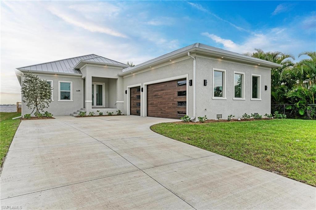 STUNNING 2025 JUST COMPLETED HARBORFRONT POOL HOME AWAITS NEW OWNERS! This custom 3 bedroom, 2.5 bathroom + den, 3 car garage WATERFRONT pool home has it all, including a metal roof, impact rated windows & doors, incredible details, including custom cabinetry with soft closure, tile floors throughout, stone counters, upgraded appliances & light fixtures, and more! As you approach the front door, notice the custom & upgraded garage doors with wood look finish. Inside, a welcome foyer is open to the spacious living room with custom ceiling details and recessed lighting, all with sweeping harbor views and incredible sunrises and sunsets! Off to the right side, find a conveniently located guest half bathroom, a large laundry room with cabinetry to leads to the garage, a spacious guest bedroom with beautiful water views and a large closet, and a separate guest bedroom with en suite bathroom access to a full bathroom with beautiful tile work in the shower. Off the foyer, the spacious office/den is a great place to work with amazing natural light and could serve as a 4th bedroom. The great room is perfect for entertaining, with a built-in bar area, and is also open to the spacious gourmet kitchen with large island/breakfast bar, corner pantry, amazing cabinet space, under counter lighting, upgraded appliances, and is also open to the dining room, all with wide water views of the harbor from multiple sliding glass doors. Off the living room, the primary suite is the ultimate retreat, with a beautiful bedroom with sliding door access to the lanai/pool, beautiful water views, dual walk-in closets, and a spa-quality bathroom with dual vanities with lighted mirrors, a lovely, tiled shower, a free-standing soaking tub with wall filler, and a private toilet room. Outside, enjoy an extra deep covered lanai, stubbed for a future outdoor kitchen with hot/cold water and drain connection, and power. The pool and spa are huge and there is still a spot to enjoy the sun as you lounge by the pool. Outside in the backyard, the concrete seawall and excellent harbor access are perfect for you to add your dock and bring your boat or launch your kayaks/paddleboards. This home also has a grandfathered in boat ramp, perfect for a small boat launch! Nearby to Punta Gorda, Sunseeker, and so many great restaurants, shops, golf, and more, this home is incredible! Prefer an unfurnished home? Check out the adjacent listing by the same builder, too! BE SURE TO CLICK THE FULL VIRTUAL TOUR LINKS FOR DETAILS!