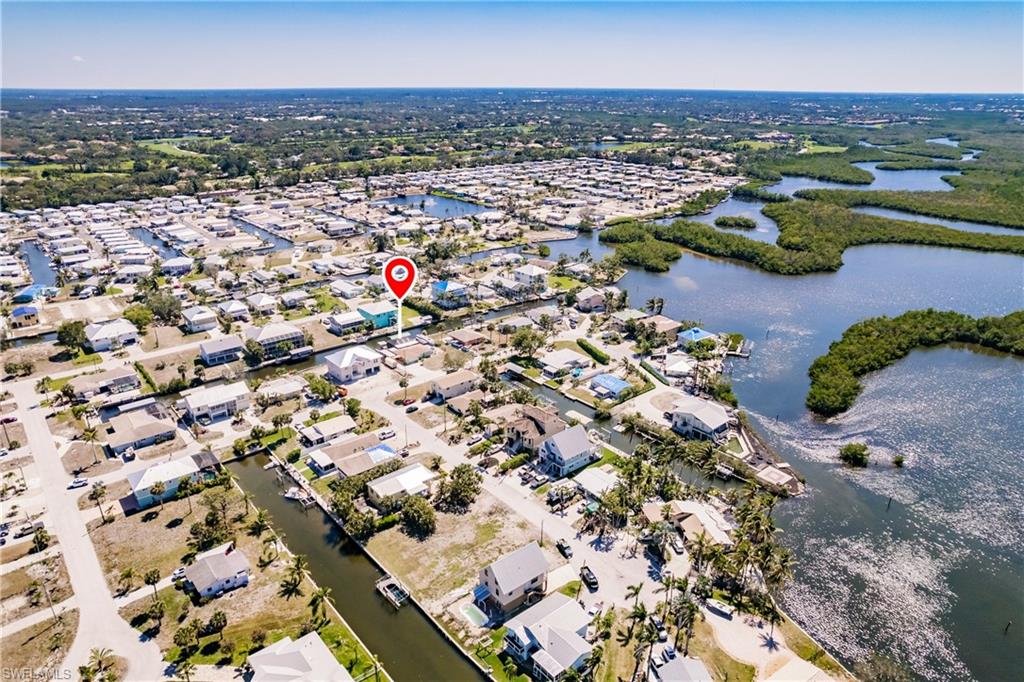 Location, Location, Location!!! The neighborhood has a lot of fantastic homes & only one mile away from this newly listed property, there is an extensive construction for the newest Ritz-Carlton Luxurious Residences in Estero Bay. They will bring an exclusive rich lifestyle to this zip code never seen before.  Translation… You can get this home at an incredible price & Once the Ritz Carlton Development is completed, this neighborhood will be one of the most desirable & expensive in the area. The Property is a Boater’s dream. Incredible opportunity to redesign, expand, customize & call this your new dream home. An oversized waterfront home with no HOA rules or Monthly fees. A huge beautiful pool, its own private boat ramp(Only 3 in the neighborhood) that feeds into a direct gulf access canal that is minutes away from Spring Creek and then the back bay. New central air system, RV pad with full 50 amp service, water & sewer hookup (Great for use as a guest house) along with a newly screened enclosure, boat lift and 30’ canopy. There is a slider out to the screened lanai with views of the canal between the living room & dining room. The Community of Estero Bay Shores is the hidden gem