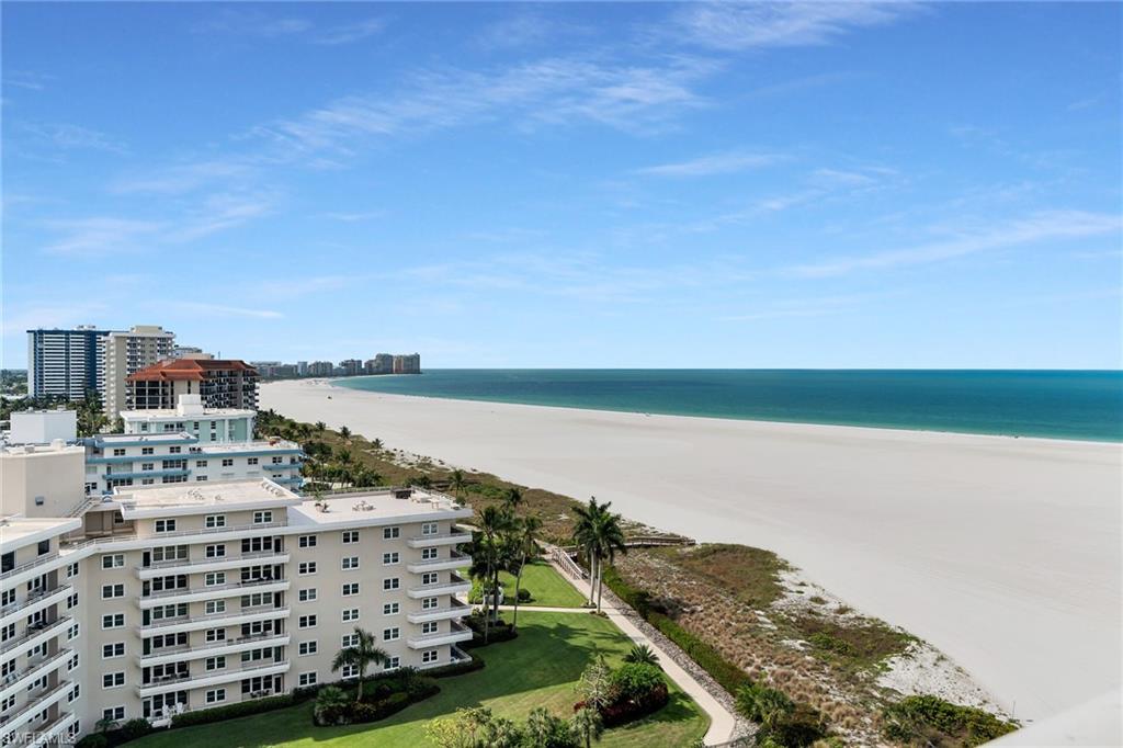 Experience coastal luxury at its finest in this beautifully renovated, designer-inspired beachfront residence at South Seas. No detail has been overlooked in this exceptional condo, where sophisticated style meets modern comfort. The stunning kitchen has been completely reimagined with elegant quartz countertops, while new tile flooring flows seamlessly throughout the home. Architectural enhancements include raised ceilings with upgraded lighting, adding warmth and dimension to every space. The spacious primary suite features a beautifully redesigned bathroom, complemented by a fully updated guest bathroom and an expanded linen closet for added convenience. Additional premium upgrades include hurricane-impact windows and doors, custom window treatments with motorized shades in the living room, high-end furnishings and décor, updated trim and moldings, new interior doors and hardware, and all-new plumbing fixtures. Perfectly positioned with sought-after southwest exposure, this residence offers year-round sunshine from the expansive lanai and breathtaking panoramic views of Marco Island's renowned white-sand beach. Even better, all current assessments have been paid in full -- allowing you to move right in and immediately enjoy the ultimate beachfront lifestyle.