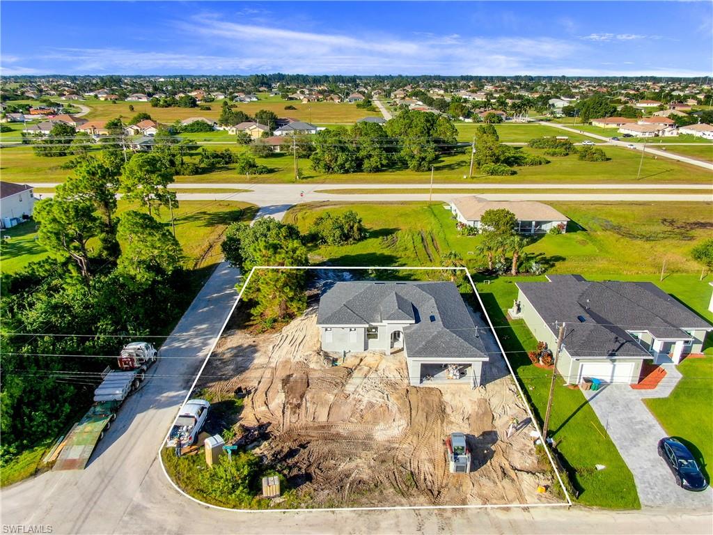 Prime Location!!! **Complete by the end of December 2020** Welcome to NW of Cape Coral, one of the fastest growing areas in the beautiful city of Cape Coral !! This wonderful modern open floor plan concept brand new  Single Family Home "Paradise model" sits  on a extended corner lot, features nearly  1,700 Sq. Ft of living space, 3  bedroom plus den,  2 Full  new bathrooms with Quartz, 2 car garage . Freshly painted inside and out, epoxy in garage, new kitchen with soft-close cabinets, Quartz counter tops, island, new stainless steel appliances, new doors, new based boards,  new  AC system, new light fixtures, new plumbing, new smoke detectors, alarm system new water heater, new well equipment. Home is equipped with Taex built-in pest control system, irrigation system,  hurricane impact doors and windows, laundry room,  Spacious master bedroom, new master bath, double-sink, 1 huge walk-in closet, new plank tile throughout the home. The location is close to many of Cape Coral top schools, closer to US 41, North Fort Myers, hospitals,  shopping, dining, entertainment & less than 40 mins to SW Florida International Airport, NO HOA Fees. This home will not last!