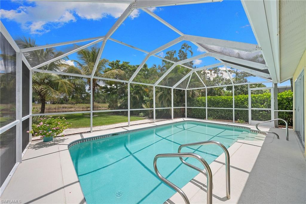 Move right in and start enjoying the Naples lifestyle in this beautifully updated pool home with rare privacy, wide canal views, and one of the lowest HOA fees in Naples at just $690 per year. Perfectly positioned on a quiet lot with no immediate neighbors across the canal, this light-filled residence offers a peaceful setting where you can enjoy spectacular water views, launch a kayak or small boat from your backyard, fish from the canal, or simply relax poolside while taking in the natural beauty that surrounds you. Beyond the pool is an expansive backyard with plenty of room for play, pets, gardening, or entertaining. Inside, soaring ceilings, abundant natural light, and thoughtful updates create a welcoming, move-in-ready home. The updated kitchen features quartz countertops, smart stainless steel appliances, and opens seamlessly to the living and dining areas. Hurricane-impact sliders surround the air-conditioned flex room, creating additional living space that can be enjoyed year-round. Major improvements include a new roof and skylights (2025), mini-split A/C system, instant hot water system, updated HVAC, smart home features, storm protection, and generator-ready electrical service. Transferable warranties and an X flood zone location provide added peace of mind. Residents enjoy Berkshire Lakes scenic walking and biking paths, clubhouse, tennis and pickleball courts, while being just minutes from shopping, dining, downtown Naples, and the Gulf beaches. This is Florida living at its best.