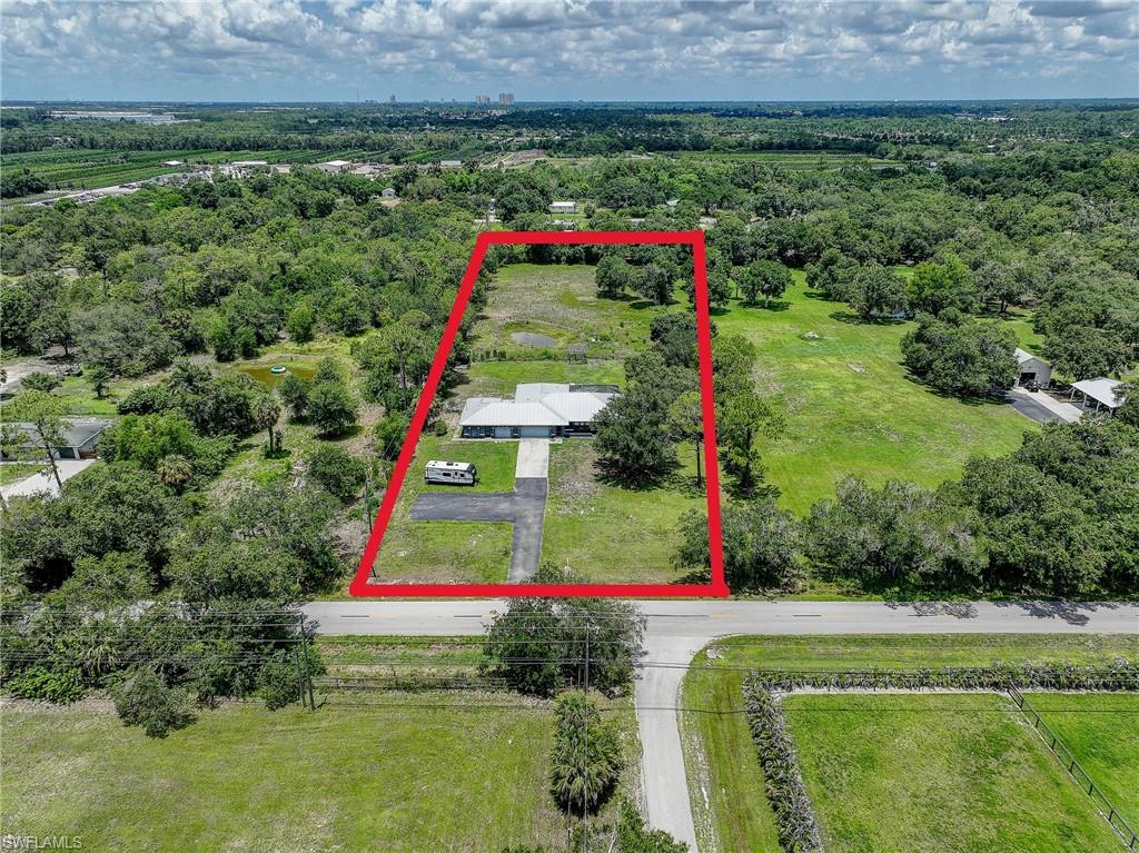 MOTIVATED SELLER WHO WANTS THIS SOLD!!  TONS OF POTENTIAL HERE!!  Welcome to your private slice of Southwest Florida paradise! Situated on 2.23 fully fenced and cross-fenced acres, this beautifully maintained 5-bedroom + den, 3-bath pool home offers the perfect blend of space, flexibility, and country charm—just a short drive from everything Fort Myers has to offer. This solid concrete block home features over 2,600 square feet of living space, designed with versatility in mind. A secondary private entrance makes it ideal for multigenerational living, guest quarters, or a home-based business. 
Step inside to find vaulted ceilings, spacious living areas, and a centrally located kitchen complete with granite countertops, stainless steel appliances, and ample cabinet space—perfect for everyday living and entertaining. 
Through the sliding doors, enjoy Florida living at its finest with a heated in-ground pool and expansive screened lanai, offering the perfect setting for relaxing or hosting gatherings year-round.  The outdoor space is where this property truly shines. Zoned AG-2, there are no deed restrictions, allowing for horses, farm animals, additional outbuildings, RV/boat parking, and more. The property includes a small pond, storage shed, and oversized driveway with extra parking, giving you endless possibilities to create your ideal lifestyle. Additional highlights include 3 car attached garage, metal roof ( installed 2012), High and dry location- not in a flood zone, built in 300 gallon saltwater fish tank and and screened in front porch entryway.  Located in a quiet, rural-feel area known for large lots and peaceful surroundings, yet still conveniently close to shopping, dining, and major roadways, this property offers the best of both worlds—privacy and accessibility. 
Whether you're looking for room to grow, a place for your animals, or a flexible home with income potential—this one truly has it all.
Schedule your private showing today and experience the possibilities!  SELLER IS OFFERING A $25,000 FLOORING CREDIT AT CLOSING FOR NEW OWNER TO REPLACE FLOORS OR SPEND AS THEY CHOOSE!!