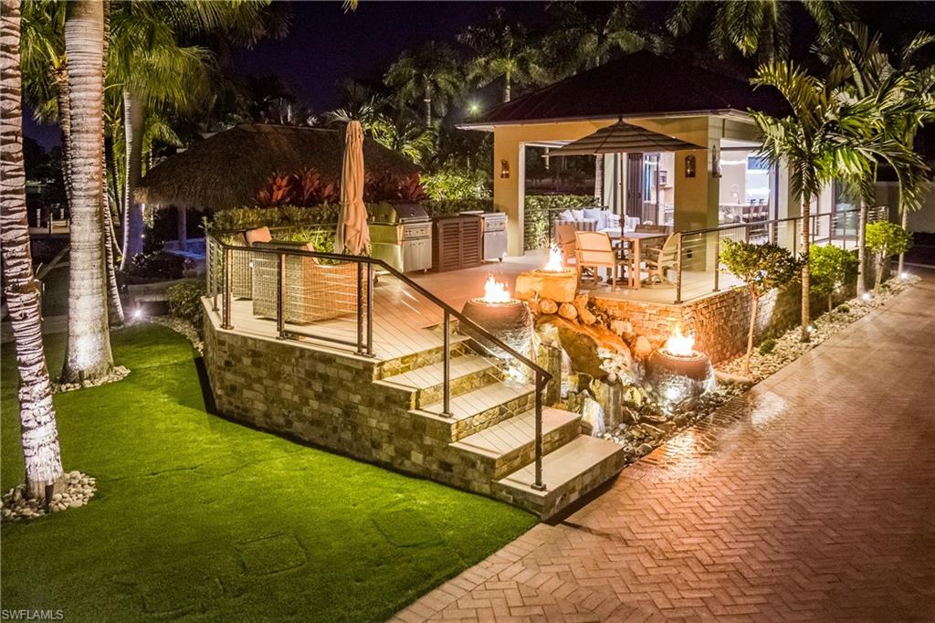 An Unparalleled Waterfront Casita Estate at Naples Motorcoach Resort on a Deeded 1.5-Lot.
Presented is an extraordinary, Gulf-access waterfront estate within the prestigious gates of Naples Motorcoach Resort, a truly rare offering that sets a new standard for luxury motorcoach living. This one-of-a-kind compound seamlessly blends refined architecture, superior construction, and resort-level outdoor living with uninterrupted mangrove and water views, all with indirect access to the Gulf.

At the heart of the property is a custom-designed, architecturally distinctive casita constructed with uncompromising quality and attention to detail. The structure is finished inside and out with a custom-color, 25-year Dryvit system, complemented by closed-cell spray foam insulation for superior energy efficiency, sound attenuation, and durability.
The interior showcases matching porcelain tile and decking throughout, creating a cohesive, elevated aesthetic that flows effortlessly between indoor and outdoor spaces. Hurricane-rated folding glass doors and insect-free motorized screens allow the living areas to be fully opened or enclosed while preserving uninterrupted views of the natural mangrove backdrop. Dedicated climate control ensures year-round comfort.
The designer kitchen and spa-inspired bath rival those found in luxury residences, featuring premium finishes, an oversized waterfall-style shower with thoughtfully positioned controls, a technology-enhanced illuminated mirror, and a top-tier automatic Toto toilet; delivering a true private spa experience.

Exterior spaces are equally impressive and designed for both relaxation and entertaining. Custom powder-coated, lighted cable railings frame the property, enhancing both safety and ambiance after sunset. A separate open-air patio intentionally left uncovered provides the perfect setting for sunbathing, entertaining, and elegant outdoor dining in the open air with space for a grill, refrigerator, dining table, and lounge seating.
The grounds are professionally landscaped with a curated selection of bamboo, gardenias, and palms, accented by automatic landscape lighting and app-controlled irrigation. Low-maintenance, high-end synthetic turf completes the outdoor environment with year-round beauty and ease of ownership. Features: In-Direct Gulf access via navigable waterways; Uninterrupted mangrove and water views; Largest dock in the resort, featuring a 15,000-lb boat lift; Hand-laid stone foundation and dramatic fire and water features; Underground propane system servicing multiple fire elements; Rooftop utilities including a 10-kW Generac generator; Options for additional covered carport parking.  This is more than a property, it is a statement of distinction, craftsmanship, and Gulf-access waterfront luxury.