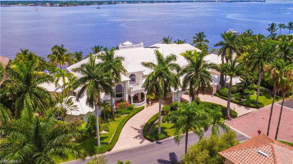 Spectacular Deep Water Riverfront Estate minutes to the Gulf of Mexico,no bridges or locks,in the finest Yachting community in SWFL.This 14,000 under air and 18,000 under roof Estate home was designed on Two Waterfront Lots with unobstructed waterfront views from Every Room. It's truly an Entertainers Dream Home!!Constructed thirteen feet above sea level with a double concrete stairwell down to your own private 225ft of natural sandy white beach.7 bed,7 1/2 baths,4 car garage, chef's kitchen with gas and electric cook tops,6 wet bars with refrigeration,glass elevator,media Room,steam room,custom rock fountain & 12-person spa.Separate 2 bed 1 bath guest house w/kitchen & laundry room.Just a short walk or bike ride to the brand new 24,000 square foot Wellness Fitness Facility that has everything you could ask for;smoothie cafe,TRX room,complimentary fitness classes,TrackMan golf simulator,cycle studio,weight room,2 restaurants & bars with indoor and outdoor dining.Resort style living at its best.Gulf Harbour Yacht &C.C.Is ranked#1 Club in SWFL for Golf,Tennis & 186-slip deep water marina.This iconic Ft.Myers Estate is truly must see!Preview tour online or book a private showing today