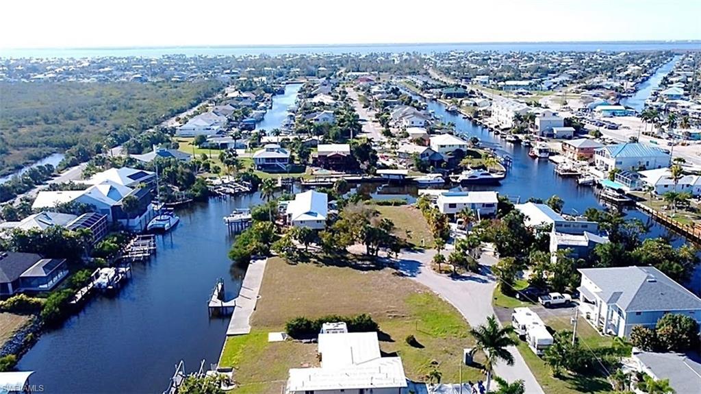Claim Your Piece of Paradise - Build Steps from the Gulf! Discover the freedom of true Southwest Florida waterfront living on this oversized Gulf-Access Triple Lot in the heart of St. James City on Pine Island. Just a short 10-minute boat ride to open water, you’ll enjoy quick access to world-class fishing, island beaches, and endless Gulf adventures. The property includes a private dock and features no bridge restrictions, allowing easy navigation for larger boats. With generous dimensions and existing fill already in place, this homesite offers an excellent opportunity to build your custom dream home while saving on materials and labor for site preparation. Tucked away on a quiet cul-de-sac canal with no through traffic, the neighborhood is perfect for walking, jogging, bike rides, or cruising by golf cart to nearby dining, marinas and St. Jude Nature Trail.