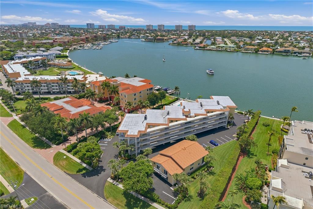 Fantastic opportunity to be in the heart of Marco Island in the low-density complex of Villa Del Mare on beautiful Smokehouse Bay. This private, end unit is competitively priced and is ready to be made like new again. Featuring a light and bright floor plan with nearly 1,400 square feet of living space, two bedrooms, two baths (the primary bath has been updated) and a spacious exterior terrace that overlooks the bay and pool. Added value of having a full-sized washer and dryer in residence, in addition to a covered parking space and storage closet. Convenient location within five minutes to the island hotspot, The Esplanade, area shopping and grocery stores, restaurants, entertainment and more. Lovely on-site amenities include a spacious community pool where you can soak in the sun and views, a common dock for boating and a common elevator. This property is extra special, as it was the last home of Marco Island’s beloved Herb and Emily Savage.