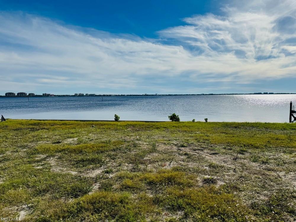 Prime location. This oversized Riverfront building site with south rear exposure is a rare opportunity amongst premium lots in Cape Coral. Combine the charm of the Yacht Club with a million-dollar-view to the Caloosahatchee River and you have the perfect location for your dream home. Neighborhood of new(er) estate homes. Seawall new in 2013. City Assessments paid.