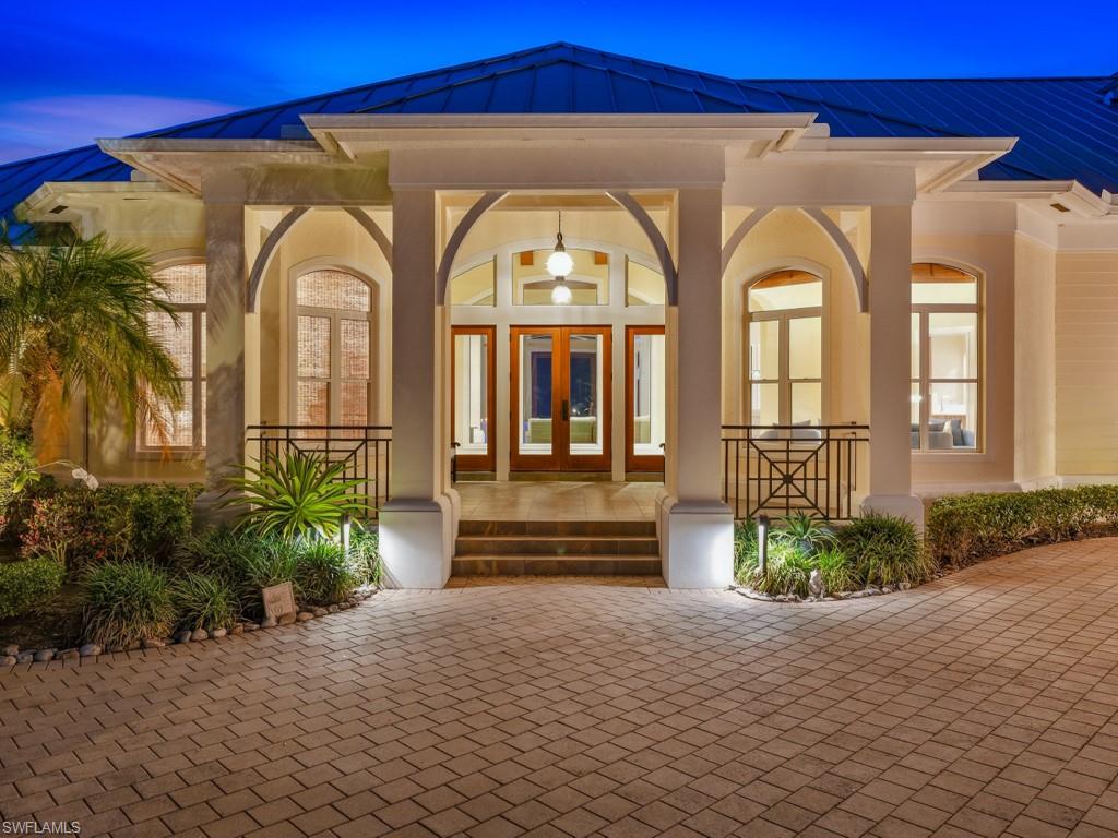Welcome to 7051 Hunters Road, a stunning custom estate home, with mature landscaped grounds, located in Livingston Woods, offering exceptional design for entertainment and casual luxury living. Enter through the beautiful front  entryway to a dramatic foyer with volume ceilings and arched wood beams, direct views of the pool, lanai and private backyard. This meticulously maintained two-story residence features 5 bedrooms plus a den, 5 full bathrooms, and a spacious 4-car garage with a bonus room ideal for car collectors, boaters,  and other outdoor sports enthusiasts. Designed for ideal indoor/outdoor living, the open-concept kitchen and great room open effortlessly through sliders to the expansive lanai, pool, and spa area and outdoor kitchen. The kitchen showcases quartz countertops, 

Jenn-Air refrigerator, Dacor microwave, dual ovens, 2 dishwashers, built-in ice maker, 2 Jenn-Air beverage refrigerators, and large walk-in pantry. The outdoor living space is equally impressive with an expansive sitting, dining and recreation areas, a built-in outdoor grill, enhanced accent lighting, and a large heated saltwater pool. The spacious primary suite features a spa-like ensuite bath, custom closets, and an adjacent private relaxing retreat area. The light-filled office, with views of the manicured front grounds, is conveniently located near the entryway.  The large guest suite, located on the east side of the home, offers private lanai access ideal for visitor or multi-generational living. Upstairs space provides 3 additional bedrooms, 2 full bathrooms, a spacious game room with generous closet and storage space. The large laundry room has built-in cabinetry and extensive countertop space. Located in a FEMA X Flood Zone and set within the expansive estate lots of Livingston Woods and nearby the Community School of Naples, First Baptist Academy.   In addition, the property is located minutes from Mercato, 5th Ave South, Artis Naples and other cultural destinations, and the beautiful Naples beaches. This exceptional estate offers the perfect blend of luxury, quality, privacy, and convenience.