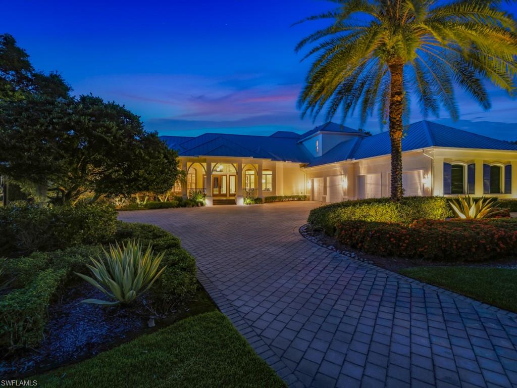 Welcome to 7051 Hunters Road, a stunning custom estate home, with mature landscaped grounds, located in Livingston Woods, offering exceptional design for entertainment and casual luxury living. Enter through the beautiful front  entryway to a dramatic foyer with volume ceilings and arched wood beams, direct views of the pool, lanai and private backyard. This meticulously maintained two-story residence features 5 bedrooms plus a den, 5 full bathrooms, and a spacious 4-car garage with a bonus room ideal for car collectors, boaters,  and other outdoor sports enthusiasts. Designed for ideal indoor/outdoor living, the open-concept kitchen and great room open effortlessly through sliders to the expansive lanai, pool, and spa area and outdoor kitchen. The kitchen showcases quartz countertops, 

Jenn-Air refrigerator, Dacor microwave, dual ovens, 2 dishwashers, built-in ice maker, 2 Jenn-Air beverage refrigerators, and large walk-in pantry. The outdoor living space is equally impressive with an expansive sitting, dining and recreation areas, a built-in outdoor grill, enhanced accent lighting, and a large heated saltwater pool. The spacious primary suite features a spa-like ensuite bath, custom closets, and an adjacent private relaxing retreat area. The light-filled office, with views of the manicured front grounds, is conveniently located near the entryway.  The large guest suite, located on the east side of the home, offers private lanai access ideal for visitor or multi-generational living. Upstairs space provides 3 additional bedrooms, 2 full bathrooms, a spacious game room with generous closet and storage space. The large laundry room has built-in cabinetry and extensive countertop space. Located in a FEMA X Flood Zone and set within the expansive estate lots of Livingston Woods and nearby the Community School of Naples, First Baptist Academy.   In addition, the property is located minutes from Mercato, 5th Ave South, Artis Naples and other cultural destinations, and the beautiful Naples beaches. This exceptional estate offers the perfect blend of luxury, quality, privacy, and convenience.