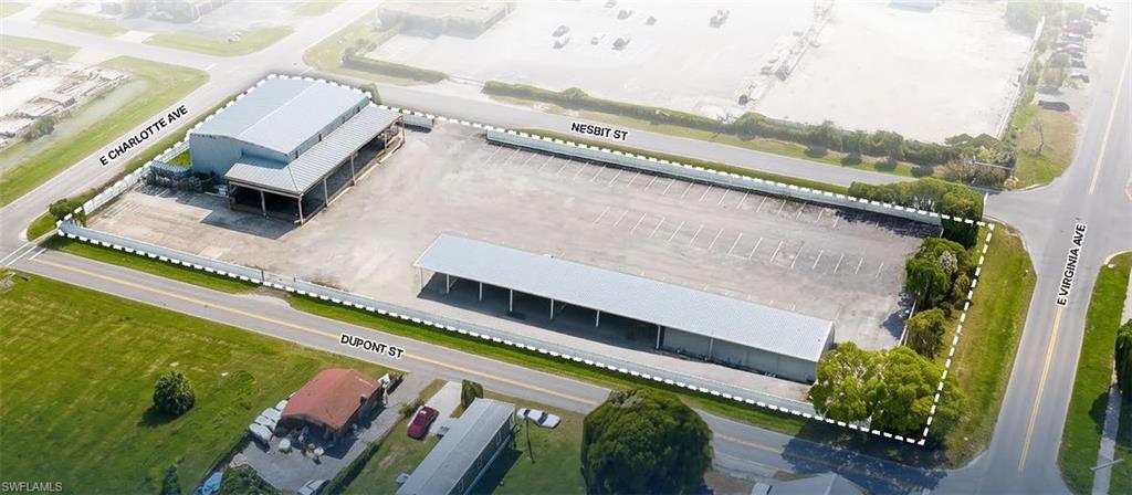 4,020± SF Industrial Warehouse: 780± SF 1st floor office, 780± SF 2nd floor mezzanine & office (not included in total size) and 23' clear height. Loading: Two (2) Dock-High Overhead Doors: One (1) 12' x 10' dock-high door; One (1) 12' x 12' dock-high door with loading ramp. Covered Storage: 6,000± SF partially enclosed storage structure. Lot Size: 1.7 acres (fully paved & fenced).  Electric gated fence access onto Nesbit Street. Approved for a variety of commercial uses including, but not limited to warehousing, distribution, light industrial uses, parking & vehicle/boat sales and service.
