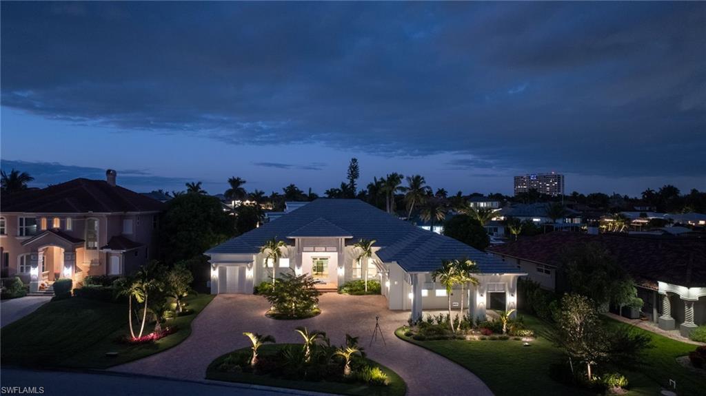 Situated within one of Southwest Florida’s most coveted direct-access boating communities, this exceptional PGI Homes–built waterfront estate at 813 Cal Cove Drive embodies timeless Palm Beach sophistication with a distinctly modern edge. Polished yet inviting, the residence was thoughtfully designed to balance everyday livability with effortless, high-level entertaining. From arrival, the quality of craftsmanship is unmistakable. Interiors are defined by custom millwork, designer built-ins, statement flooring and countertops, and a carefully curated selection of lighting and plumbing fixtures that lend the home a refined, fashion-forward presence. The chef’s kitchen anchors the main living space, featuring Wolf and Sub-Zero appliances, premium finishes, and a seamless flow ideal for intimate gatherings or larger-scale entertaining. Architectural detailing, expansive ceiling heights, and refined materials elevate each room with a sense of quiet confidence and enduring style.
Outdoor living is executed at a similarly high level, offering a private, resort-style setting complete with a fireplace, expansive pool, oversized spa accommodating ten or more guests, a dedicated in-ground cold plunge, and a fully equipped outdoor kitchen. Boating enthusiasts will appreciate the composite dock with lift and covered boathouse, providing quick, direct access to open water.
Additional features include a whole-house generator, electric roll-down screens throughout the lanai, and a three to four car garage complemented by a covered porte-cochère with roll-down screened parking. Exterior finishes were intentionally selected for both impact and longevity, incorporating tabby shell, smooth stucco, composite materials, architectural hardscape elements, and low-maintenance artificial turf to create a striking yet durable coastal aesthetic.
Offered furnished, the residence allows for a seamless transition into a lifestyle defined by sophistication, comfort, and effortless waterfront living.