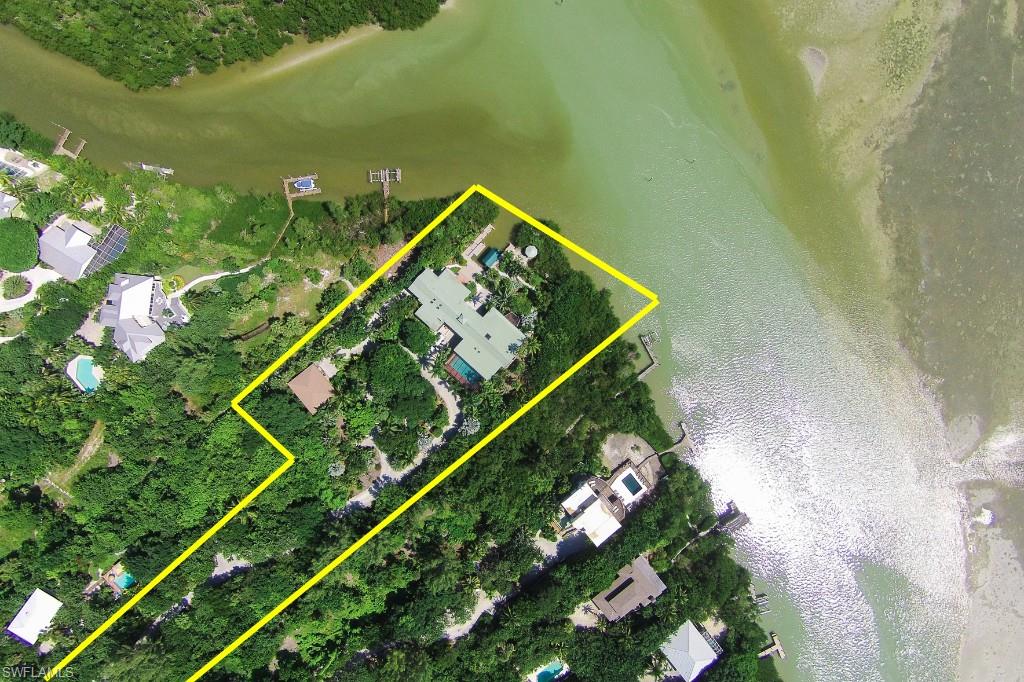 One of Captiva's most iconic residences resting on 2.5 acres with 200 ft of bay-frontage overlooking the sparkling waters toward the preservation land beyond. As you approach up the shell drive you are surrounded by mature specimen plantings from around the globe that can only come with decades of establishment and deliberately arranged garden paths highlighting many exotic species. Upon arrival you are greeted with bay views before even entering due to the wonderful breezeway design which looks through to the wrap around covered boat basin and gazebo. As you enter, you are welcomed with a hand forged cascading stairway which brings you to the interior for a knockout view. This sprawling one level home design is only possible because of the double water frontage of 200ft. Unequivocally the ultimate home for entertaining, with a massive relaxing area along with an knockout outdoor kitchen, spa and huge pool along with billiards and more. Remember to visit the guest house too. Unlike any other location on the Islands', here the wildlife entertainment is endless from wading spoonbills to diving brown pelicans and the manatees along with dolphins passing by.