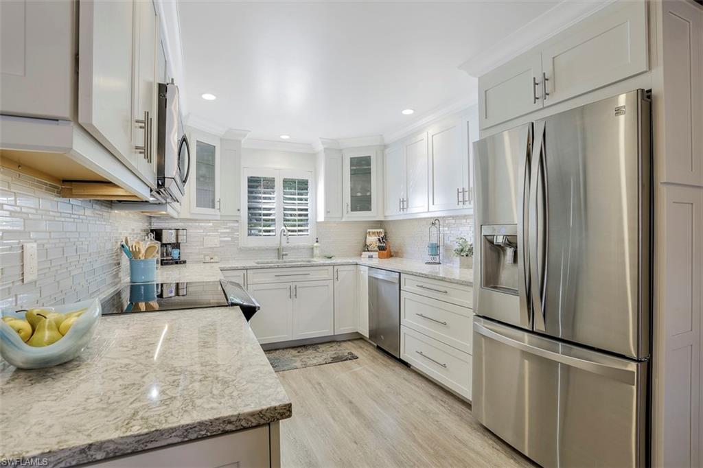 Beautiful Move-In-Ready Gulf Access Condo! located on the desirable Rubicon Canal. This 2-bedroom 2- bathroom first floor unit has been completely remodeled with no expenses spared. The work has been done for you and features a spacious kitchen with upgraded white wood shaker cabinetry, stunning quartz counter tops with tile back splash, and stainless-steel appliances. Crown molding throughout the unit and wood-like flooring throughout the main living area and one bedroom, tile in bathrooms and carpet in the bedroom. The guest bathroom has a tub/shower combo and the master has a nice sized walk in shower with new tile and river rock flooring with a new sliding barn-like door for privacy. Both the Living Room and The Master Suite Lead to the spacious tiled Lanai with sliding glass doors that disappear into the walls for that open floor plan with great water views. This first-floor unit is just steps away from the community pool at Country Club Condos.