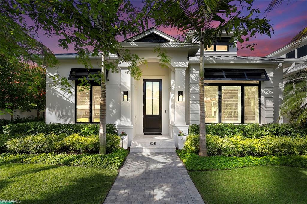 Welcome to your dream coastal retreat, built in 2023! This stunning home boasts four spacious bedrooms and five full baths along with a convenient half bath, ensuring ample space for family and guests. Just five blocks from the pristine beach and a mere three blocks from vibrant shopping, dining, galleries and theater of 5th Avenue, you’ll enjoy the ideal blend of relaxation and entertainment. Step outside to discover a serene water feature and a luxurious spa, complemented by a sparkling pool, ideal for soaking up the sun or hosting gatherings. The screened lanai, equipped with retractable screens, allows for year-round enjoyment of your outdoor space. Additional highlights include a whole-house generator and dual primary suites, ideal for comfort and privacy. The home is outfitted with a state-of-the-art Sonos sound system and a two-car garage with an EV charger, making it as functional as it is beautiful. Don’t miss your chance to own this remarkable property! The layout of this modern home is designed for luxury and functionality. Upon entering, you are welcomed into a spacious open-concept living area, seamlessly connecting the living room, dining space, gourmet kitchen and outdoor space, ideal for entertaining. The main floor features one of the primary suites, which boasts an en-suite bath and a generous walk-in closet and access to the pool. This home also features a dedicated office as well as a pool bath. The upper level is dedicated to privacy, featuring the second primary suite along with additional bedrooms and baths. Each bedroom offers ample natural light and space. The fourth bedroom can also be used as a flex room or media room, providing additional space for the family to gather. This oversized room also connects to the second story sun deck. The oversized elevator ensures easy access throughout the home, making it accessible for everyone.