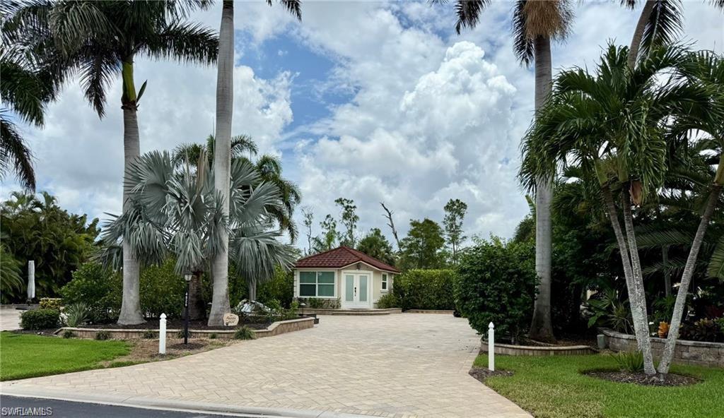 Site Details: This large, upgraded off-lake Class A Motorcoach site spans approx. 5227 square feet and has been upgraded with a full paver block pad with raised wall edging, a built-in water fountain, 308 square foot coachhouse, outdoor custom kitchen with sink, grill, Blackstone, granite countertop prep space, and storage, and private, tropical landscaping with night lighting and a Mosquito Joe pest control system. Located on the north side of Pelican Lake Motorcoach this is a back-in site with Southern exposure in a serene quiet area. Take advantage of this move-in ready site which includes some indoor furniture with other items negotiable. Coach house Details: Custom built in 2015 and remodeled in 2022, this coachhouse has a floor plan that includes everything needed to enjoy this RV lifestyle. The floor plan includes a full bathroom with stand-alone shower, toilet, and vanity, washer and dryer, full kitchen with modern black cabinets and white countertops, and spacious living area with large tv. The air conditioning split system was recently replaced.