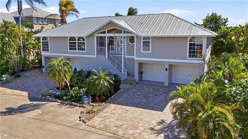 Rare luxury coastal residence located on a quiet cul-de-sac within the coveted Fairview Isles boating community, offering expansive, well-maintained indoor and outdoor living spaces designed for elevated island living. Desirable southern exposure provides sweeping waterfront views overlooking a natural inlet on Estero Bay, creating a serene and private coastal setting.
Outdoor living is exceptional, featuring a sunny pool and balcony ideal for enjoying tranquil backyard surroundings and water views. The private dock includes a boat lift designed to accommodate a pontoon boat. Thoughtfully designed exterior lighting and lush, distinctive landscaping enhance the elegance and character of the property, evoking a natural preserve–like atmosphere.
An expansive driveway leads to four garage doors, providing abundant under-building parking and storage. An elevator offers convenient access from the garage to the main living level. A ground-level bonus area includes an under-air game room that opens directly to the pool deck, offering flexible space for entertaining and recreation.
The open floor plan seamlessly connects indoor and outdoor living areas, creating an entertainer’s dream. The luxury kitchen serves as the heart of the home, complemented by a cozy fireplace that adds warmth and ambiance to the living space.
Enjoy direct Gulf access by boat and Fort Myers Beach access via a neighborhood walkway, delivering the ultimate blend of boating, beach access, and refined island living.