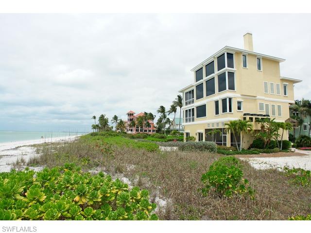 Rarely available direct Gulf front home in Barefoot Beach. Massive commercial size & quality glass windows overlook gorgeous Gulf of Mexico views. Only the finest materials can be found throughout, incl marble flooring, custom cabinetry, granite counters & so much more. The master suite offers stunning views from a wall of glass that makes you feel as if you are right on the beach. The master also includes a private sitting area w/full wet bar, large closet & a spacious bath w/a whirlpool tub offering direct Gulf views. All bedrooms offer baths as well as the den complete w/built-in desk & shelving. The Grand 2-story living room presents mesmerizing views of the Gulf via a wall of glass from floor to ceiling. A 4th floor media rm includes a built-in humidor, wet bar & retractable movie screen w/the Gulf in the background. Solid concrete construction and elec shutters enclose the entire house. A truly fantastic one-of-a-kind home.