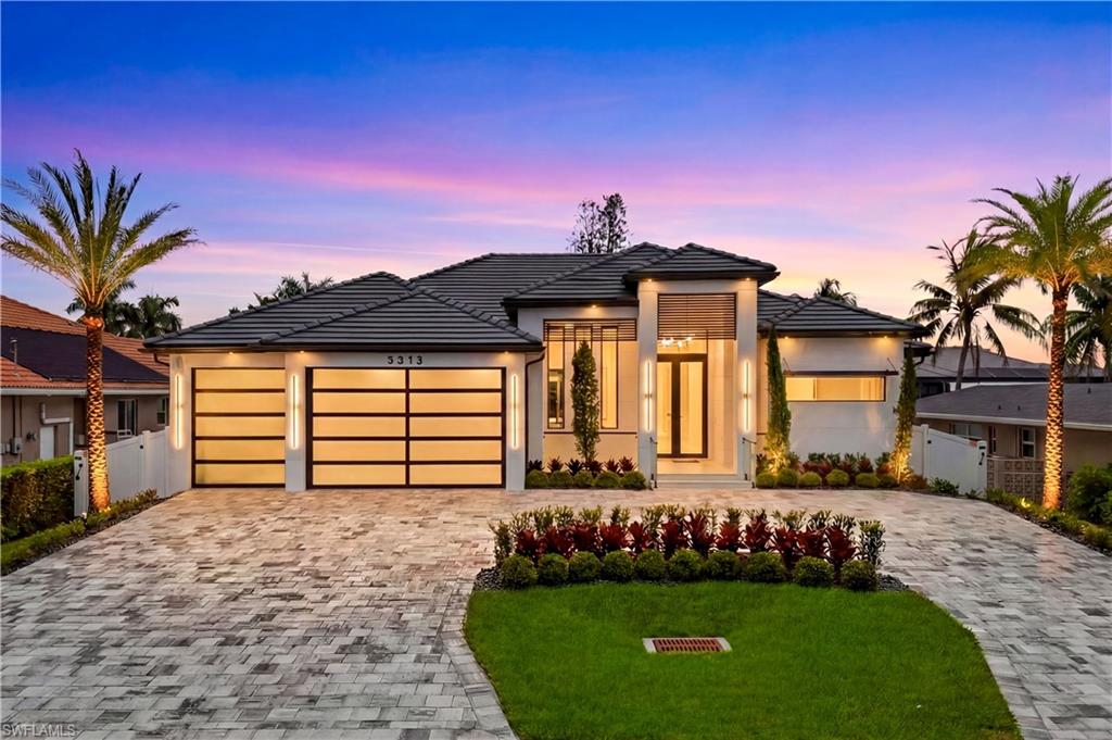 YATCH CLUB WATERFRONT ESTATE with DIRECT GULF ACCESS, NO BRIDGES & just 4 MINUTES to OPEN WATER & BEYOND! Designed for LUXURY WATERFRONT LIVING, this EXCEPTIONAL OASIS showcases HIGH-END FINISHES, STUNNING CANAL VIEWS, UNMATCHED BOATING ACCESS & YEAR-ROUND RESORT-STYLE LIVING! Enjoy 80 ft of COLONY CANAL frontage, CAPTAIN'S WALK, 10,000-lb BOAT LIFT, TIKI HUT & FULLY EQUIPPED DOCK. Bright & open modern layout featuring oversized 72x41 SPANISH PORCELAIN TILE. Arrive through MARBLE-COLUMN FRONT PORCH w/ glass accents & modern wood ceiling, opening to IMPRESSIVE FOYER w/ 10-ft TINTED Low-E IMPACT-RESISTANT DOUBLE DOORS. STRIKING ENTRYWAY w/ designer’s CHANDELIER & built-in FEATURE WALL w/ CUSTOM CABINETRY & integrated LED ACCENT LIGHTING, perfect for showcasing art, books, or décor! Living room w/ 16-ft COVE CEILING, flat wood panels & beam detailing, ITALIAN WALLPAPERED FEATURE WALL w/ custom cabinetry & LED-lit shelving, 75" TV & INTEGRATED BOSE SURROUND SOUND SYSTEM. GOURMET KITCHEN w/ modern design & PREMIUM CRAFTSMANSHIP equipped w/ LUXURY APPLIANCES, Liebherr built-in DUAL-ZONE WINE COOLER, Viking FLAT RANGE w/ DOUBLE CONVECTION OVENS, INTEGRATED DISHWASHER, custom built-in Liebherr SIDE-BY-SIDE REFRIGERATOR/FREEZER & Miele INTEGRATED COFFEE MACHINE. Trade-Wind commercial-grade HOOD concealed w/ custom cabinetry. OVERSIZED WATERFALL island highlighted by CRISTALLO QUARTZITE LIGHTING PENDANT & by top-of-the-line CABINETRY extending to the ceiling w/ under- & upper-cabinet lighting, CRISTALLO QUARTZITE COUNTERTOPS, full-height backsplash, POT FILLER & large sink w/ spring single handle faucet add on. SOPHISTICATED FORMAL DINING w/ TRAVERTINE FEATURE WALL, wood ceiling, designer lighting, and 9-ft tinted Low-E sliders plus oversized windows to the WATERFRONTAGE offering views of COLONY CANAL, SPA & POOL & DOCK. SPLENDID MASTER BATH w/ FULL GLASS WALL, DOUBLE RAINFALL SHOWERS w/ 4 jets & handheld showerheads, STANDALONE TUB & custom vanities. All bathrooms feature SEAMLESS TRAVERTINE INTEGRATED SINKS w/ SOFT VEINING & WALL-MOUNTED SMART TOILETS w/ BIDET FEATURES & CONCEALED in-wall TANK SYSTEMS for MODERN LOOK. All bedrooms feature ELEGANT TRAY CEILINGS w/ WOOD INLAY ACCENTS. SPLIT FLOOR PLAN w/ 2nd PRIMARY SUITE, 2 GUEST BEDROOMS & HALLWAY BATHROOM ensure PRIVACY & convenience for FAMILY & GUESTS! Step outside to your WATERFRONT PROMENADE w/ OVERSIZED HEATED SALTWATER POOL & SPA, MARBLE PAVERS, artificial turf, LUSH LANDSCAPING & fenced yard. OUTDOOR KITCHEN w/ Bull grill, side burner, hood, fridge, sink & storage & covered patio w/ wood ceiling, fan, INTEGRATED BOSE SURROUND SOUND SYSTEM & 65” TV. Laundry room w/ LG washer & dryer, utility sink w/ full backsplash, L-shaped countertop & ample STORAGE. Circular driveway, 3-CAR GARAGE w/ IMPACT RESISTANT LOW-E GLASS PANELS & INSULATED CEILING. Offering DIRECT GULF-ACCESS BOATING & REFINED COASTAL LUXURY, this EXCEPTIONAL HOME is a RARE OPPORTUNITY to ENJOY THE VERY BEST OF SOUTHWEST FLORIDA LIVING!
