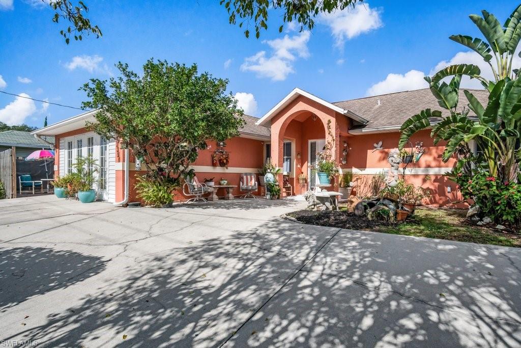 BACK OVERSIZED lot! Spacious 3 bed, 2 bath home in a quiet neighborhood in Bonita Springs - ready to move in with room for the whole family! Foyer leads into the open floor plan with large living room, bright white kitchen with stainless steel appliances and breakfast bar with adjoining dining area. Tile flooring throughout. Sliders lead out to large backyard with plenty of room for a pool. Framed by mature hedges and fence for privacy, and a paved patio area for enjoying the sunshine. Garage has been converted to an in-law suite with AC, tile flooring, kitchenette and private bath with shower. NO HOA fees or rules! Prime location near beaches, Riverside park, Bonita Springs dog park, Everglades Wonder Gardens, Shangri-La Springs, restaurants, shopping, and schools. Easy access to I-75 and close to the airport.