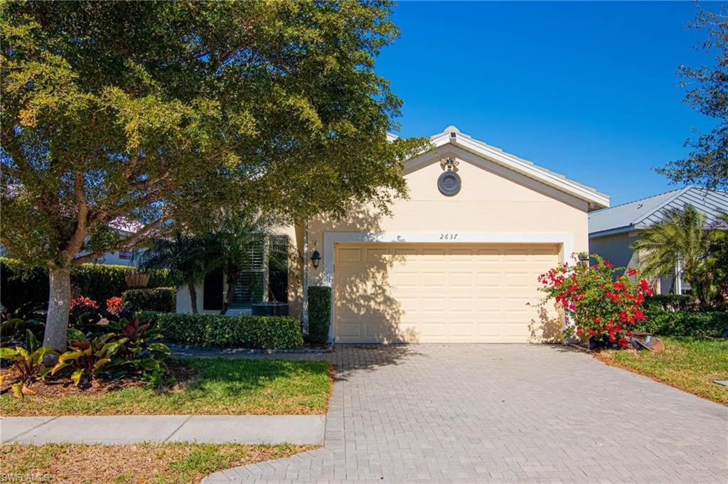 Welcome home to this beautifully maintained 3-bedroom plus den, 2-bath home offering a bright and open floor plan with volume ceilings and elegant tray details. Tile flooring flows throughout the main living areas. The spacious kitchen features granite countertops, stainless steel appliances, a pantry, and ample cabinetry—perfect for everyday living and entertaining. Step outside to the screened lanai overlooking mature landscaping, creating a peaceful outdoor retreat. The guest bathroom includes a dual-sink vanity, while the owner’s suite boasts a walk-in closet, dual-sink vanity, and a large walk-in shower. The versatile den can easily serve as a home office or optional fourth bedroom, adding flexibility to this thoughtfully designed home. Sandoval is known for its relaxed lifestyle living with plenty of activities for all ages! RESORT STYLE POOL, FISHING PIER, 2 DOG PARKS, KIDS PLAYGROUND, BOCCEBALL, VOLLEYBALL, BASKETBALL AND TENNIS COURTS just to name a few. Call today for your private showing and to own a piece of this paradise!