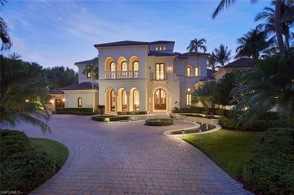 Immediate golf membership available. The lush panoramic lake and golf course views of the exclusive Estuary golf course capture you immediately upon entering the double Mahogany doors and grand coquina stone detailed foyer of this custom home. The 5-bedroom, 6-full/2-half-bath plus study and media room estate has a new roof installed in 2023 and Tischler mahogany framed impact windows and doors throughout the over 7,600 square feet of this well-designed floor plan. The many updates in the home include a completely updated chef’s kitchen with Wolf/Sub-Zero appliances, Taj Mahal quartzite countertops and stunning walnut wood flooring. The kitchen flows into a spacious dining nook overlooking the incredible view and a cozy family room with authentic wood beam ceiling detail. The outdoor living is a perfect setting to enjoy Naples sunsets with a large screened-in covered lanai featuring gas grill, beverage drawers and a gas fireplace with marble surround. The oversized infinity edge heated pool and sunken spa have also been updated and seem to drop seamlessly into the lake beyond. A spacious private cabana bedroom and a plush media room are perfect for entertaining friends and family. Additional features of this meticulous estate include 3-car plus golf cart attached garage spaces, climate-controlled wine room, wood-paneled study and dual primary bathrooms. A world of luxury awaits you in the exclusive Grey Oaks Country Club community complete with 54 holes of championship golf and world-class amenities all within a short drive of downtown Naples.