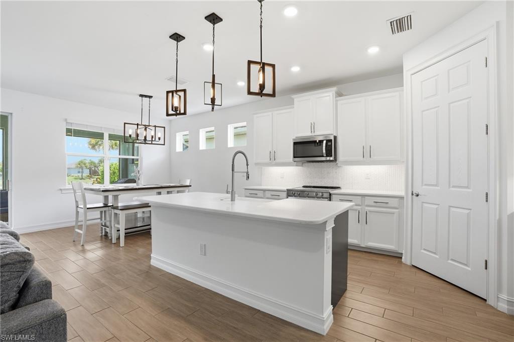 Stunning Delray floor plan in Seasons at Bonita! This open, light filled 4 bedroom, 2 bath home with 2,032 sq. ft. under air and expansive lake and fountain views. Built in 2022 with tile throughout and not located in a flood zone, this modern residence offers plenty of outdoor potential with room for a pool or a fenced backyard to maximize the view and entertaining space. Low HOA dues provide exceptional value while granting access to outstanding community amenities including tennis and pickleball courts, a fitness center, resort pool, lap pool, hot tub, bocce, and two dog parks. Enjoy serene lakefront living with resort-style conveniences!