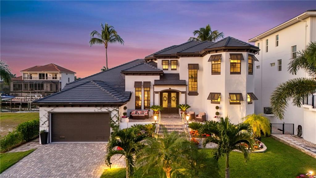 *Luxury at an irresistible value — the most attractively priced property in The Conners, appraised at $4.3 million* Welcome to 427 Willet Avenue in the highly coveted Conners of Vanderbilt Beach. This coastal retreat, offered furnished and ready for you to enjoy, is designed for effortless Florida living and unforgettable entertaining. Rich hardwood floors flow throughout, complemented by vaulted ceilings that fill the home with natural light and an airy, open feel. Your future home features two luxurious primary suites, including a desirable main-floor primary bedroom and a second story primary, perfect for privacy, comfort, and easy everyday living. Versatile and practical spaces like the split bedroom floor plan, generously sized den, and entertainment loft/media room ensure everyone in the family has a dedicated space. Step outside and you’ll find the true showstopper: a resort-style backyard complete with a heated pool and spa, a fully equipped gas outdoor kitchen, 2025 BOAT and JET SKI DOCK AND 13,000 lbs BOAT LIFT outfitted with a covered fishing station and plenty of space to dine, lounge, and gather under the sun and stars. 

Let's talk peace of mind: Impact Windows and Doors Throughout; *all equipment raised after Ian* 2025 POOL HEATER & EQUIPMENT, 2025 BOAT DOCK/MOTORS, 2024 TANKLESS WATER HEATER, 2023 GARAGE STORM DOOR & MOTOR, 2022 AC, newly leveled pavers, and automatic lanai screen system ensuring seamless indoor/outdoor living! 

Whether you’re hosting friends after a day at the beach or enjoying a quiet evening poolside, this home is an entertainer’s dream and the perfect place to savor the paradise that is Naples, Florida.