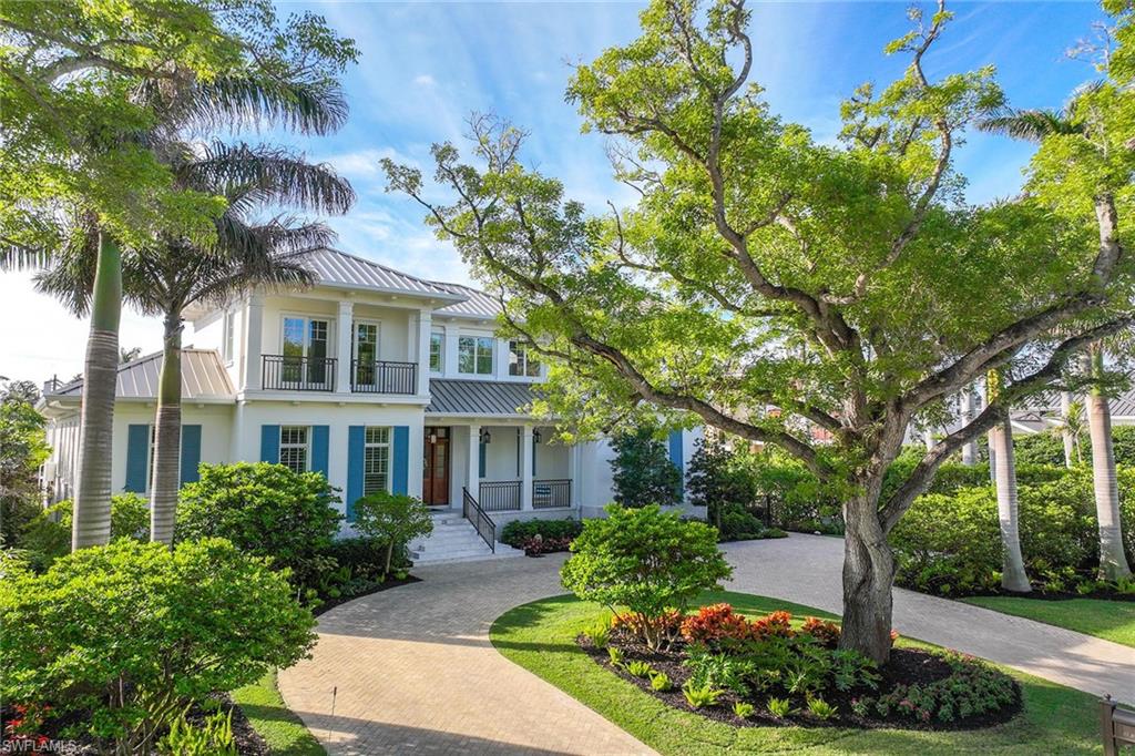Just one home from the beach, this custom-built residence on a desirable corner lot at Gulf Shore Boulevard and 1st Avenue N blends elegance and superior craftsmanship with modern design. Created by Stofft Cooney and Big Island Builders in 2019, this home boasts exceptional finishes, including imported marble and wood flooring, intricate tilework and fixtures, custom impact doors and windows, and elevator. On an enchanting Mahogony tree-lined street and built for durability featuring two levels of concrete block construction, an elevated foundation, a custom metal roof and whole-house generator. The chef’s kitchen includes a Lacanche Volnay range, and Wolf and Sub-Zero appliances. The great room opens to a screened lanai with an Alfresco grill, overlooking a private pool and lush gardens framed by a tiled wall and mature landscaping. The first floor has a luxurious primary suite with an office, a large second bedroom with en suite, a library and an inviting family room. Upstairs offers two additional bedrooms with en suites, a lounge and bonus spaces. With southern exposure, outdoor living, gulf-view balconies and dog run, this home provides tranquility and privacy in a prized, Old Naples location. Resilient during hurricanes Ian and Milton, according to the owner, the house and pool deck had no water intrusion or loss of power.