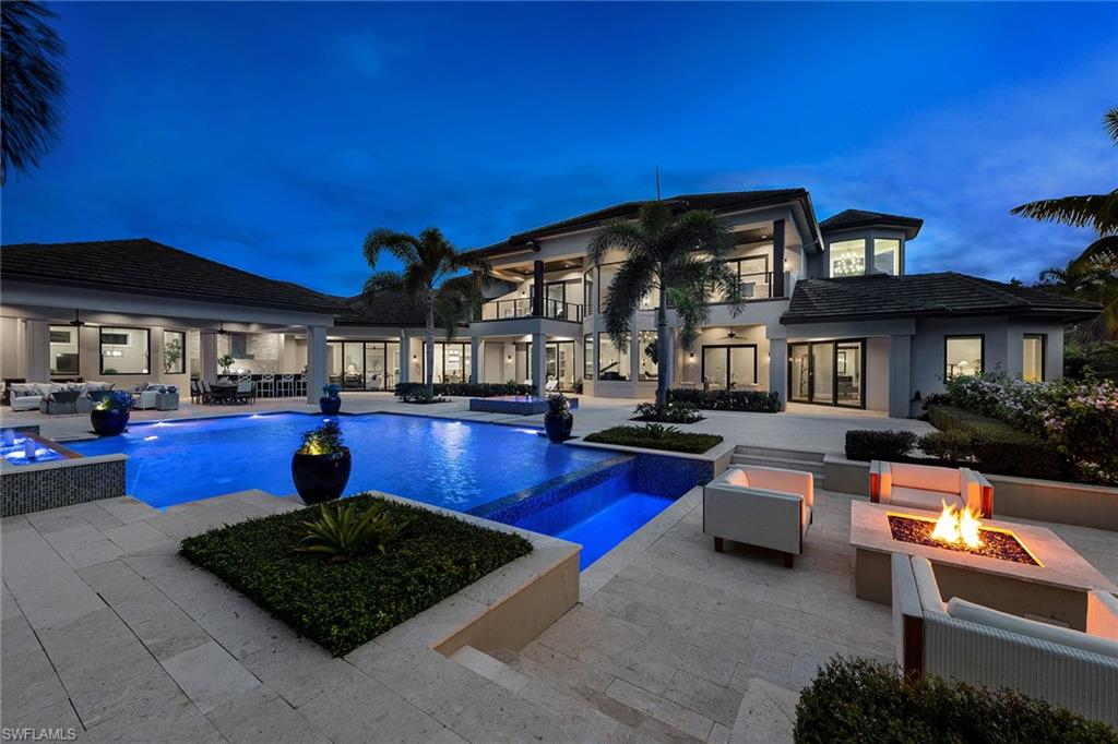 Situated among 2.36 acres in sought-after Pine Ridge Estates, this custom home offers infinite possibilities for your ideal lifestyle. Built in 2017, the modern coastal-style estate encompasses 9,155 square feet of living space. The interior greets you with an open floor plan and delicate design. Built to the highest standards, attention to detail abounds with floor-to-ceiling windows, natural lighting, floating ceiling design, recessed cove lighting and walnut wood floors. Boasting a master suite with a sitting area, four additional bedroom suites, two home offices and a game room, there is plenty of space for extended family and guests. A gourmet kitchen with Wolf appliances, catering kitchen and wine cooler offer the perfect environment for entertaining. Further features include a wardrobe dressing room, large living room, family room, dining room and a four-car garage. Out back is an oasis with a summer kitchen and bar overlooking the infinity-edge pool with fountain, spa and gas fire pit. Pine Ridge Estates is close to Waterside Shops, Mercato, as well as Fifth Avenue South and the Gulf of Mexico. This meticulous masterpiece invites you to enjoy Florida living at its finest.