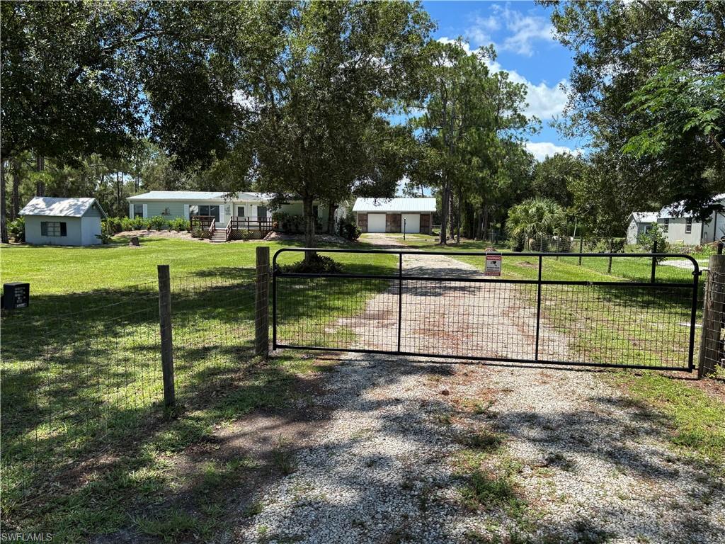 Rare opportunity to own 2.78 fully fenced acres in the peaceful countryside of Ft. Denaud, Florida! Finding acreage like this is becoming increasingly difficult, making this property an exceptional opportunity for those looking for space, privacy, and versatility.

This well-maintained 1,568-square-foot manufactured home has been freshly painted inside and features new laminate flooring, creating a bright, updated interior. Recent improvements include a 3-year-old central air-conditioning system, a whole-house reverse osmosis water system, and a roof replaced in 2017.  You'll also enjoy an additional 440-square-foot air-conditioned Florida Room, providing extra living space that's perfect for entertaining, relaxing, a home office, or hobby room.

Step outside onto the inviting 12' x 20' wood deck, where you can enjoy your morning coffee while taking in the peaceful country setting and abundant wildlife.

One of the property's most impressive features is the 1,600-square-foot detached concrete block building with three overhead garage doors. Whether you need a workshop, garage for vehicles and equipment, storage for recreational toys, or space for a home-based business, this solid block building offers possibilities that are rarely found. Unlike many outbuildings, this one is built of durable concrete block, providing strength, security, and long-term value. The garage roof was replaced in 2022, adding even more value to this exceptional building.

With room to spread out, plenty of parking, and endless possibilities, this property offers the best of country living while still being within convenient driving distance of shopping, dining, and everyday amenities.

If you've been searching for acreage, a move-in-ready home, and an oversized workshop that is nearly impossible to find, this property deserves a place at the top of your list!