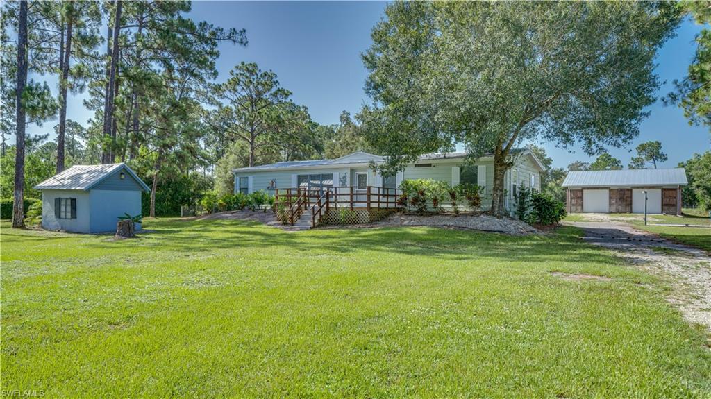 Rare opportunity to own 2.78 fully fenced acres in the peaceful countryside of Ft. Denaud, Florida! Finding acreage like this is becoming increasingly difficult, making this property an exceptional opportunity for those looking for space, privacy, and versatility.

This well-maintained 1,568-square-foot manufactured home has been freshly painted inside and features new laminate flooring, creating a bright, updated interior. Recent improvements include a 3-year-old central air-conditioning system, a whole-house reverse osmosis water system, and a roof replaced in 2017.  You'll also enjoy an additional 440-square-foot air-conditioned Florida Room, providing extra living space that's perfect for entertaining, relaxing, a home office, or hobby room.

Step outside onto the inviting 12' x 20' wood deck, where you can enjoy your morning coffee while taking in the peaceful country setting and abundant wildlife.

One of the property's most impressive features is the 1,600-square-foot detached concrete block building with three overhead garage doors. Whether you need a workshop, garage for vehicles and equipment, storage for recreational toys, or space for a home-based business, this solid block building offers possibilities that are rarely found. Unlike many outbuildings, this one is built of durable concrete block, providing strength, security, and long-term value. The garage roof was replaced in 2022, adding even more value to this exceptional building.

With room to spread out, plenty of parking, and endless possibilities, this property offers the best of country living while still being within convenient driving distance of shopping, dining, and everyday amenities.

If you've been searching for acreage, a move-in-ready home, and an oversized workshop that is nearly impossible to find, this property deserves a place at the top of your list!