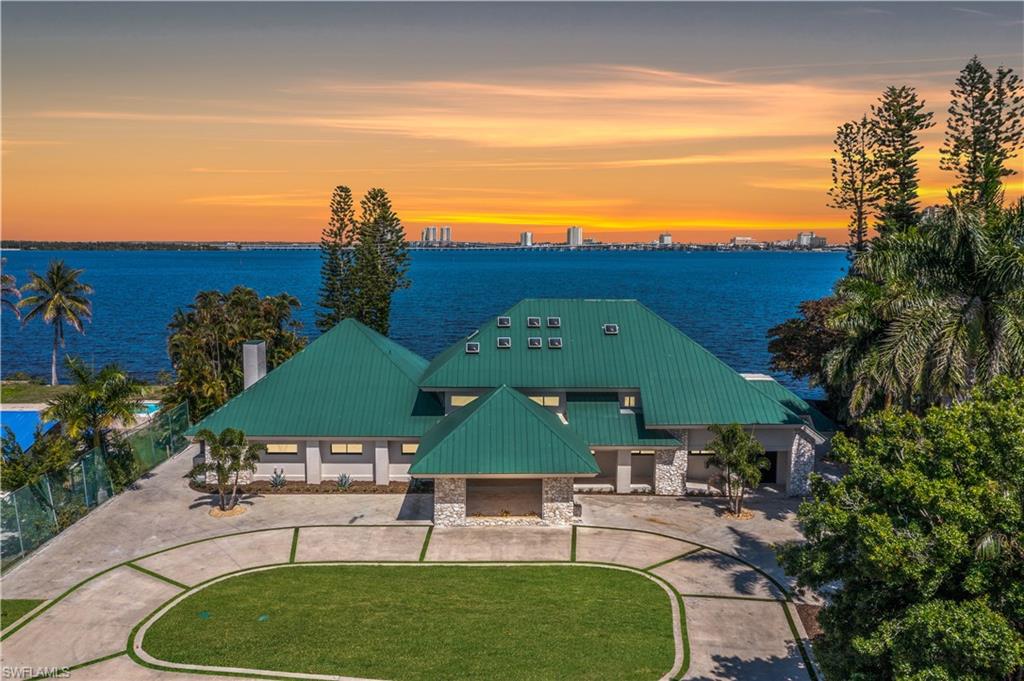Welcome to 752 Overiver Drive. This stunning estate offers unobstructed panoramic views of the Caloosahatchee River with the Downtown Fort Myers skyline shimmering across the water. Set in the quiet residential enclave of Overiver Shores in North Fort Myers, this fully reimagined waterfront residence offers the rare combination most buyers only dream about: complete privacy and serenity on one side, and one of Southwest Florida's most dynamic urban skylines on the other. Offering 5 bedrooms, a workout room, 5 full bathrooms, and over 6,000 square feet of living space, this estate offers a uniquely expansive layout unlike anything available today. The home has been transformed from the ground up — no compromises, no shortcuts, nothing left unfinished. Completely replumbed with PEX, all new electric panels & wiring, four brand new state-of-the-art HVAC systems & duct work, PGT impact windows & doors, high impact garage doors, and so much more, this home is the definition of move in ready. The design work throughout is unmatched. Step through the front door and the first thing you notice is the staircase. Designed by a world renowned interior designer and hand-fabricated by master craftsman Lawrence Voytek — a collaborator of Robert Rauschenberg — it is a functional sculpture, one born from a genuine creative collaboration. It sets the tone for everything that follows. And everything that follows delivers. The interiors were conceived by an artist from start to finish and exudes Hollywood regency design, creating a sense of flow and intention that moves through every room. Finishes were curated, not selected off a shelf: plumbing by Ferguson, tile and surfaces by ProSource, custom cabinetry crafted by Designs by Distinction, closet systems by Florida Closets, Emtek hardware by Smith & DeShields, lighting and accessories by Lighting First, and luxury appliances from FUSE Specialty Appliances. High-end Berber carpeting and tile floors are throughout. Outside, a resort-caliber pool anchors a professionally landscaped yard with turf that extends to the water's edge. An irreplaceable feature of the back yard is the private boat launch. A fully monitored alarm system, sound system, and Wi-Fi infrastructure are already in place. For this home, there is nothing to renovate, nothing to update, nothing to wait on. Just an exceptionally designed waterfront estate. Where the river is your backyard and the skyline as your view, this property offers more than any other in Southwest Florida.