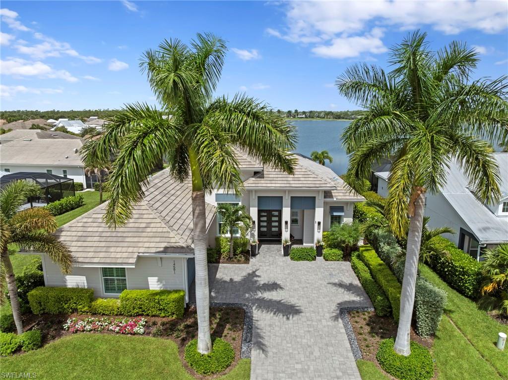The only STOCK built home on the navigable 125-acre lake w/LONG LAKE SUNSET VIEWS. 600sqft OVERSIZED GARAGE for 2 cars+golf cart. Custom features: REMODELED KITCHEN, WOLF GAS COOKTOP, WARMING DRAWER, STEAM & AIR FRYER feature double CONVECTION OVENS, 42" BUILT-IN FRIDGE/FREEZER, CAMBRIA QUARTZ WATERFALL ISLAND, DOUBLE IRON ENTRY DOOR, WHOLE HOUSE GENERATOR, 500 GALLON BURIED PROPANE TANK, 2-SIDED OUTDOOR GAS FIREPLACE, electric HURRICANE SCREENS, garage AC MINI-SPLIT, garage COMMERCIAL EPOXY FLOOR, OUTDOOR KITCHEN, OUTDOOR SHOWER, IMPACT GLASS WINDOWS/DOORS throughout, SMART HOME AUTOMATION, WHOLE HOUSE SURGE PROTECTOR. Extensive custom details: HARDWOOD FLOORS, CUSTOM CLOSETS, PLANTATION SHUTTERS, BOARD AND BATTEN wood detailing, 4" WINDOW TRIM, 7" COVE CROWN MOLDING, 10" BASEBOARD, 2-PANEL SOLID CORE DOORS, 2 sets of POCKETING 10' SLIDERS, 10'-15' CEILINGS. Open floor plan designed for entertaining & effortless living. This home offers a refined COASTAL STYLE. Perfectly positioned on an UPGRADED 80’ WIDE WATERFRONT LOT w/PROFESSIONAL LANDSCAPING/LIGHTING & lake-fed IRRIGATION SYSTEM. 4 bedrooms+den/3.5 baths. Front porch opens to a grand entry w/VIDEO DOORBELL & custom lighting. Great room features WOOD PANELED COLUMNS, SHIPLAP ACCENT WALL, SONOS SPEAKER SYSTEM, FLOOR OUTLET, ceiling fan & leads to the covered/screened lanai. Chef’s kitchen features SOFT-CLOSE cabinetry, ROLL-OUT TRASH, extended MARBLE BASKETWEAVE TILE BACKSPLASH, under CABINET LIGHTING, QUARTZ counter, EXTERIOR-VENTED HOOD, WINE FRIDGE & CUSTOM WALK-IN PANTRY. Primary suite offers tranquil LAKE VIEWS, TRAY CEILING, French doors to the lanai & 2 WALK-IN CUSTOM CLOSETS. Spa-like primary bath features dual vanities, SOAKING TUB, linen cabinet & LARGE FRAMELESS GLASS TILE-TO-CEILING SHOWER w/niche, BENCH, RAIN HEAD & HANDHELD SHOWER. Beds 2 & 3 share a Jack-N-Jill bath w/FRAMELESS GLASS SHOWER & dual vanities. Bed 4 includes an ENSUITE BATH & WALK-IN CLOSET. POOL BATH provides convenient lanai access. Den w/15' ceiling. Laundry room includes ELECTROLUX WASHER/DRYER, extended counter, utility sink & cabinetry. The extended NO-SEE-UM PICTURE SCREEN enclosure surrounds CUSTOM LEATHERED MARBLE LANAI TILE w/SHIPLAP COFFERED CEILING, SPEAKERS, ceiling fan, see through GAS FIREPLACE & CAMERAS. OUTDOOR KITCHEN has a GAS GRILL, fridge, EXTERIOR-VENTED HOOD & granite counter. HEATED SALTWATER POOL w/360 SPILLOVER SPA, SUNSHELF w/ BUBBLERS, DECK JETS, AUTOFILL & COLOR-CHANGING LIGHTS create a private resort-style oasis overlooking the lake. Additional highlights include, GARAGE STORAGE SYSTEM/CABINETS, insulated attic, ATTIC PULL-DOWN STAIR & KEYPAD ENTRY. Located in a guard-gated community w/LAWN MAINTENANCE & resort-style amenities: lakefront clubhouse w/NEW KITCHEN & TIKI BAR, FITNESS CENTER, LIFESTYLE DIRECTOR, water sports, tennis, PICKLEBALL, trails, DOG PARKS, etc. This exceptional home offers luxury, technology & an unmatched waterfront lifestyle. TRANSFERRABLE LOW RATE FLOOD POLICY