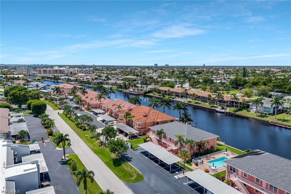 Gulf access condo just minutes from downtown Cape Coral! Situated on the Rubican Canal with over 200 feet of waterfront views, this beautifully updated 2-bedroom, 2-bathroom condo offers the Florida lifestyle you've been dreaming of. Step inside to a bright and open floor plan featuring new luxury vinyl plank flooring throughout for easy maintenance. The spacious kitchen is equipped with granite countertops, updated appliances, a pantry, plenty of counter space, and a breakfast bar that's perfect for entertaining. The living area flows seamlessly to a private west-facing balcony, providing the ideal spot to enjoy your morning coffee or take in breathtaking Florida sunsets over the water. The owner's suite offers private lanai access, stunning canal views, a large walk-in closet, and an en-suite bathroom featuring a tiled walk-in shower. Enjoy added peace of mind with a newer A/C system (2024) that was recently serviced in May, a water heater replaced in 2022, hurricane-impact windows in the primary bedroom, and a hurricane roll-down screen on the lanai. The well-maintained Ocean Isle Rubican community provides even more value with a newer seawall (2018), composite docks (2018) that allow you to keep your boat right outside your backyard, updated carports (2018/2019), fresh exterior paint (2025), and a new roof and soffits (2024). Low HOA fees include flood insurance, water, garbage, pest control, and lawn maintenance, making for truly low-maintenance living. Conveniently located in the heart of Cape Coral, you'll be within walking or biking distance of downtown Cape Coral's shopping, dining, and entertainment. Nearby attractions include Cape Harbour, Tarpon Point, top-rated schools, medical facilities, local beaches such as Sanibel, Captiva, and Fort Myers Beach, as well as easy access to area airports. Whether you're looking for a seasonal retreat, investment property, or year-round residence, this waterfront condo checks all the boxes. Don't miss your opportunity to own your slice of paradise, schedule your private showing today!