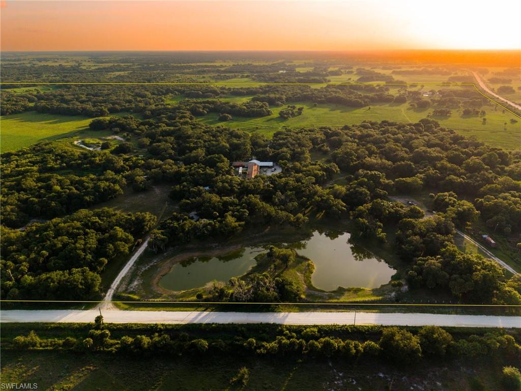 **K & P Ranch** is a rare opportunity to own one of Southwest Florida's premier recreational and agricultural properties. Encompassing approximately **445± acres of mostly upland native Florida landscape**, this legacy ranch offers exceptional hunting, ranching, and investment potential in southern Hendry County, just **45 minutes from Naples and Fort Myers**.

Home to the historic **Turkey Barn**, formerly owned by Florida agricultural pioneer **Ben Hill Griffin**, the property played an important role in raising and releasing wild **Osceola turkeys** to strengthen native populations throughout South Florida. Today, the ranch continues to support abundant wildlife, including Osceola turkeys, white-tailed deer, wild hogs, and numerous native species.

Located at the **County Road 833 and Hill Grade Rd intersection**, K & P Ranch is approximately **30 miles north of the Big Cypress National Preserve**, **5 miles east of the Okaloacoochee Slough Wildlife Management Area**, and **30 miles southwest of Lake Okeechobee**. Surrounded by large working ranches, sugarcane fields, sod farms and state-owned conservation lands, the property offers outstanding privacy while remaining easily accessible.

The ranch is **fully fenced and cross-fenced** and currently has an active **cattle lease**, with one improved pasture maintained as a **sod field**. The expansive open fields also create an outstanding setting for dove hunting and provide ample room for private skeet and sporting clays shooting, making K & P Ranch an ideal destination for year-round outdoor recreation. An extensive network of swamp buggy and side-by-side trails provides access throughout the property, winding through scenic pine flatwoods, open pasture, and beautiful native oak hammocks.

Designed for sportsmen, the property includes **multiple deer feeders, game cameras, and elevated hunting stands** already in place. Two recently updated **3-bedroom, 1-bath homes** provide comfortable accommodations for owners, guests, or ranch staff. Three gated entrances offer convenient access and operational flexibility.

Adding to its unique history, **Discovery Channel's "Naked and Afraid"** recently filmed a season on the ranch, with the campsite still remaining on the property.

Importantly, K & P Ranch is **free of conservation easements**, providing exceptional flexibility for agricultural, recreational, residential, and long-term investment use. For buyers seeking additional acreage, the **adjacent 150± acres are also available for purchase from a separate owner**, creating the opportunity to assemble nearly **600 contiguous acres with paved road access from CR 833**.

Whether you're searching for a premier hunting and sporting property, working cattle ranch, family retreat, corporate getaway, or legacy investment, K & P Ranch offers a rare combination of history, wildlife, productivity, and Old Florida beauty that is becoming increasingly difficult to find.