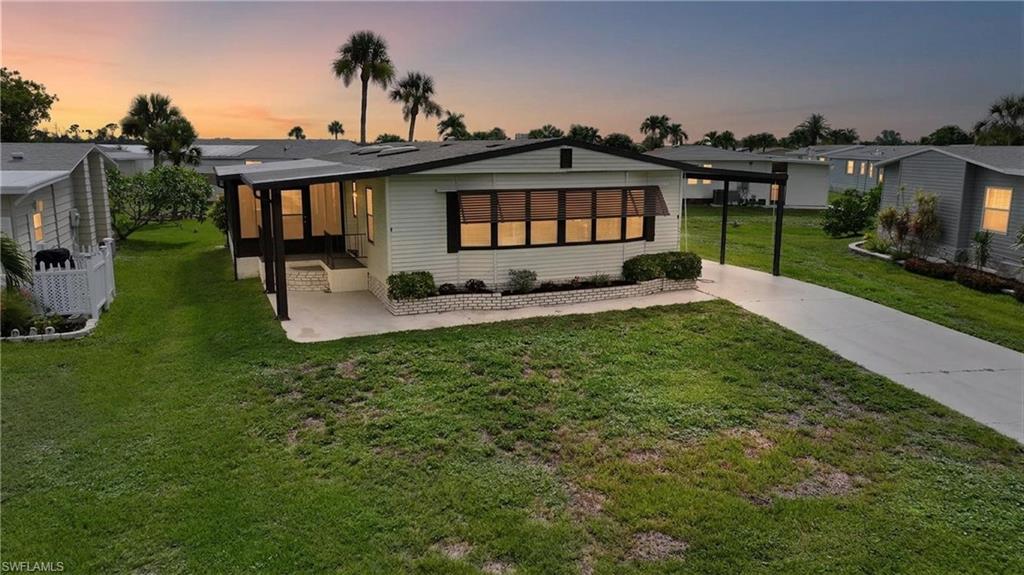 Welcome to carefree Southwest Florida living in this beautifully maintained, fully furnished 2-bedroom, 2-bath manufactured home located in the sought-after 55+ community of Lee Plantation. Offering approximately 1,481 square feet of living space, this bright and inviting residence features an open-concept layout with updated wood-look flooring throughout the main living areas, spacious living and dining rooms, and abundant natural light from multiple skylights. The well-appointed kitchen provides generous cabinet and counter space, stainless steel refrigerator, built-in oven, breakfast bar, and a cozy dining nook perfect for everyday living. The spacious primary suite offers a walk-in closet, dual-sink vanity, private water closet, and walk-in shower, while the guest bedroom and bath provide comfortable accommodations for family and friends. An oversized enclosed Florida room creates the perfect space to relax, entertain, or enjoy year-round indoor-outdoor living. Outside, you'll appreciate the covered carport, attractive landscaping, and low-maintenance yard. Residents enjoy exceptional resort-style amenities including a heated pool and spa, clubhouse, shuffleboard courts, covered gathering areas, and beautifully maintained grounds, creating an active and welcoming lifestyle. The home is conveniently located just minutes from Fort Myers Beach, Sanibel Island, shopping, dining, golf courses, medical facilities, and everyday conveniences. Whether you're looking for a seasonal retreat or full-time residence, this move-in-ready home offers outstanding value, comfort, and the best of Southwest Florida living. The property is located in Lee Plantation Phase 1 and was built in 1986, offering approximately 1,481 square feet with 2 bedrooms and 2 bathrooms