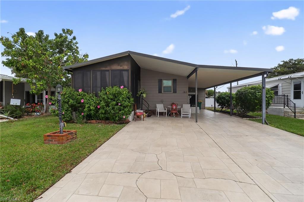 Discover comfortable, low-maintenance living in this well-maintained 2-bedroom, 2-bath mobile home located in the desirable gated Windjammer Village. Cozy and inviting layout with a relaxing patio/sunroom for year-round enjoyment. This charming home provides the perfect blend of tranquility, convenience, and community engagement in one of Naples' most sought-after 55+ neighborhoods. Ample parking and a dedicated storage room with an included washer and dryer. Additional rear parking space available for your RV, boat, or extra vehicle. Ideal for residents seeking a peaceful Florida retreat. Gated entry for added security, very close to shopping centers, medical facilities, and renowned restaurants, boutiques, cultural attractions, and don't forget the beautiful Gulf beaches and all the recreational opportunities.