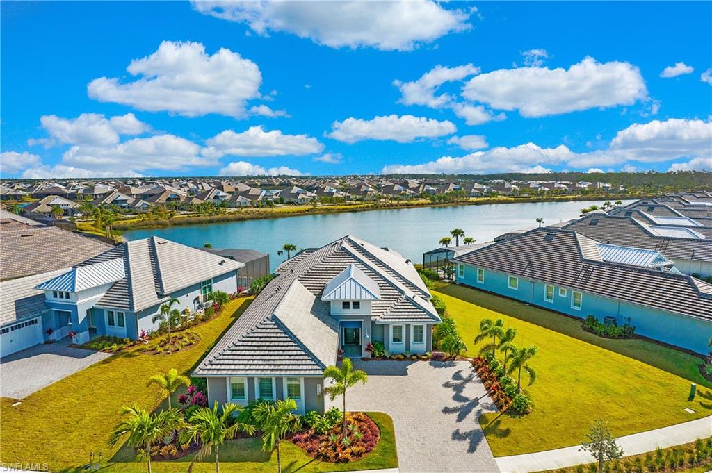 Looking for smart luxury and an incredible Naples location? This masterfully upgraded, turnkey, 2020 STOCK home in Isles of Collier Preserve has 4 bedrooms + office, 3.5 bathrooms, and stunning lake views. The Easton floorplan was thoughtfully designed, maximizing style and function, with volume ceilings and an abundance of natural light. Impact glass throughout, remote-control storm screens, and a whole-home generator provide ease of mind and efficiency. Built for entertaining, the kitchen is a perfect gathering space, with an expansive quartz island, ample seating, and a built-in bar. The Owner’s suite opens to the lanai, overlooks the lake, and is a true oasis. Three additional bedrooms and a well-equipped home office with custom built-in cabinetry provide a multitude of possibilities. Transition seamlessly from indoor to outdoor living on the expansive screened lanai with outdoor kitchen and massive fire table. Enjoy views of the pool and spa overlooking the sparkling lake. The Isles of Collier provides amenities galore: 8 miles of kayak and biking trails along the Cypress Waterway, an Old Florida style clubhouse, fitness center, pool & spa, tennis, pickleball, and more!