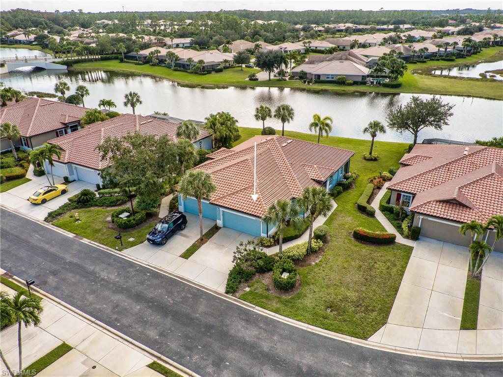 Just in time for season...this low maintenance turnkey WCI attached villa is the ideal home for seasonal and year-round use. Located in the Verona neighborhood of Pelican Preserve this home has one of the best water views throughout the community. The large yard provides plenty of room to expand your outdoor living area or even add a private pool. All homes in this section had new tile roofs, soffits, gutters, and exterior paint completed in 2020. The gas hot water heater and AC systems are less than 4 years old. New leather GR sofa, MB king bed, plantation shutters and new lanai screen were added this summer. The town center is the hub for all your social, fitness and sports activities making it easy to stay fit and entertained from the indoor aquatics center, 2 outdoor pools, staffed fitness & wellness studios, organized tennis & pickleball, wood shop, arts & crafts studios, special interest clubs, 99 seat movie theater, 2 on-site restaurants, outdoor concert pavilion, miles of walking & biking paths. Pelican Preserve is located near activities, all kinds of retail shopping, local and national restaurants, beaches, medical and the international airport is an easy 20-minute drive.