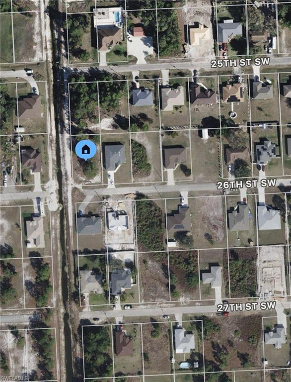 Corner lot in 33976 next to new construction home! Paved road and electric at the curb. Call today for more information.