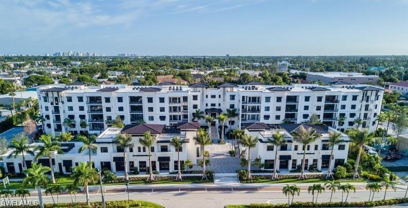 This beautifully appointed west facing corner Delray residence (3BR, 3.5BA + Den) includes an oversized garage with a dehumidification system, located directly across from the lobby.  The garage provides two assigned parking spaces with EV chargers.  Featuring 10-foot ceilings (except where dropped) and 8-foot solid core doors. The gourmet kitchen offers upgraded Irpina cabinetry with 42-inch uppers and soft close doors/drawers, upgraded quartz countertops and backsplash (extended into the pantry), a large working island, and a full Thermador appliance package including gas cooktop, stainless hood, and under counter wine chiller. Hardwood flooring runs throughout, complemented by shiplap accent walls in the great room and primary suite, recessed lighting, and designer finishes. An oversized column-free balcony with gas grill/outdoor kitchen enhances the living space. Additional upgrades include a wet bar, custom millwork and barn door by D&V Custom, Inspired Closets in all storage areas (including pantry), upgraded tile and countertops in all bathrooms, a newly added bar, and a complete Lutron lighting system with motorized shades, Control 4 integration, and TV remote. Premium light fixtures, new furnishings, and a dehumidification system in the secure under building oversized garage, located directly across from the lobby, further elevate the home. The garage provides two assigned parking spaces with EV Chargers and climate-controlled storage. Residents will enjoy extensive resort style amenities, including a 90 foot lap pool with beach entry, cabana bar with TVs and island seating, gas grills, hammocks, bocce court, life size chess, billiards, courtyard park with putting green, yoga lawn, fenced dog park, social room with catering kitchen, state of the art fitness center with private massage rooms, theater, game room, six guest suites, bike racks, and a private community shuttle to downtown. Ideally located just steps from Fifth Avenue South, Baker Park, Tin City, Naples Pier, Gulf beaches, and Third Street South. A highly sought after Old Naples address—offered furnished and ready for immediate occupancy.