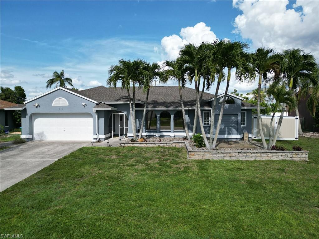 Welcome Home to 111 SE 21st Ave, Cape Coral, FL

Nestled along a picturesque palm tree-lined street, this stunning 3-bedroom plus den, 2-bathroom home offers the perfect blend of style, comfort, and Southwest Florida charm. From the moment you step inside, you'll notice the thoughtful craftsmanship — elegant crown moldings, soaring high ceilings, and beautiful tile flooring flowing throughout an inviting open-concept layout.

The updated kitchen showcases gorgeous granite countertops and serves as a natural gathering spot for family and friends. The spacious master bedroom with beautiful wood flooring features two generous walk-in closets, while the private den at the rear of the home — complete with French doors — provides a versatile retreat ideal for a home office or cozy reading nook.

Step outside and discover your personal paradise. The extended screened lanai is perfect for year-round entertaining, overlooking a fully fenced backyard adorned with mature fruit trees and plenty of room to add your dream pool. A sprinkler system keeps the landscaping lush and effortless.

This home also delivers practical perks, including a two-car garage with a bonus refrigerator that conveys, an Arlo security system, and city water with all assessments fully paid.

The surrounding neighborhood enhances the lifestyle with nearby Kurt Donaldson Community Park and Waterway Park just minutes away, plus convenient access to Cape Coral Hospital. This is Florida living at its finest — don't let this opportunity slip away!