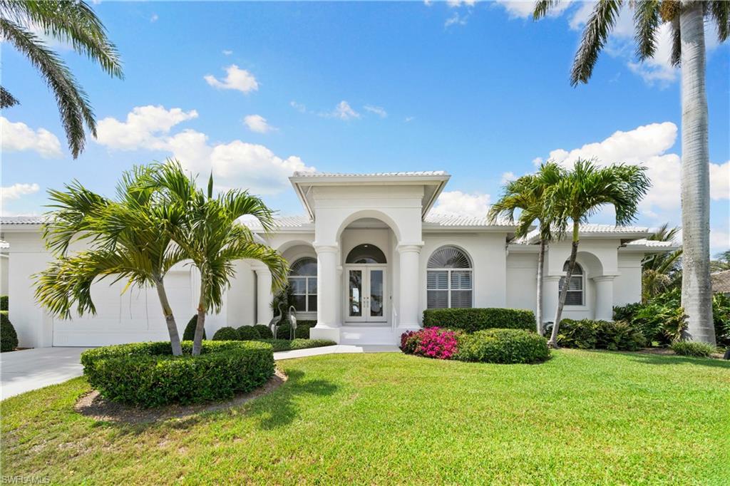 Framed between the royal palms, 529 Tigertail Court is a true waterfront masterpiece - offering one of Marco Island's most breathtaking, unobstructed, widest water views over Collier Bay. Stepping through double glass doors presents an architectural masterpiece - a perfectly refined living space where every corner is bathed in mesmerizing water views. Towering 13-foot ceilings, soft recessed lighting, twin 9-foot picture windows, and 10-foot sliding doors that vanish into the walls create a seamless dance between indoor luxury and outdoor tranquility on the water. The exquisitely modern kitchen, complemented by a vision of crisp white and cream tones, is equipped with a double oven, cutting-edge induction cooktop, and top-tier appliances - all set against the backdrop of a sprawling lanai and the shimmering expanse of Collier Bay. The luxurious master suite is a true retreat, featuring direct lanai access and an expansive bay window accentuating another private water view. The master bath contains all the essentials - his-and-hers closets and vanities; a spa-inspired walk-in shower; and a soaking tub perfectly positioned to capture another unique view of the water. The bespoke den is outfitted lined with custom cabinets and built in bookshelves and brings you a workspace with a stimulating scene right from your desk. The guest suites are a private haven, each with attached en-suite bathrooms, lanai access, and ample closet space. Every inch of this home warms you with coastal splendor while offering ideal modern hallmarks.  

This home is ideally situated on 100' of direct access waterfront. This expansive western exposure view overlooking Collier Bay is one of a kind. Your private dock and seawall is outfitted with a 12,000 lbs lift and provides a short ride out to the majestic Gulf of America and the wonders of the 10,000 Islands. With a modern tile roof, full hurricane protection, elevated dual-zone AC, and prominent elevation - this home has been engineered to last a lifetime. This exclusive property is only available to pre-qualified buyers - call your real estate professional today to schedule your private appointment