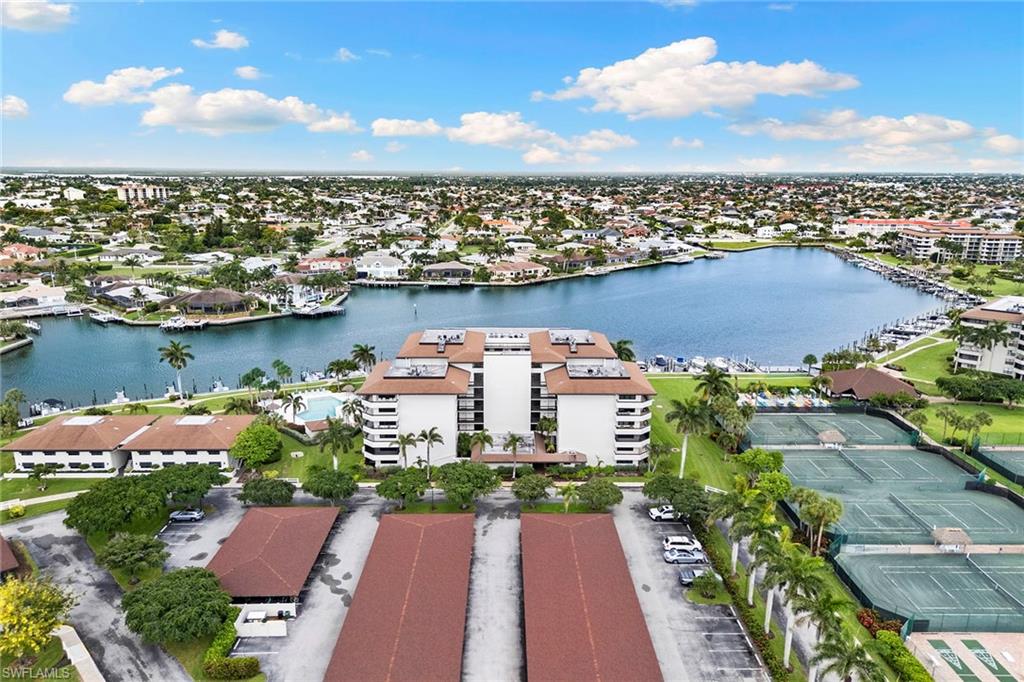 Enjoy the Marco Island lifestyle from this desirable fifth-floor residence in South Seas North. Offering two bedrooms, two baths and sought-after southern exposure, this light-filled condominium features an expansive wraparound balcony encompassing eastern views toward Clam Bay and western glimpses of the Gulf. On the southwest corner of the building, the residence offers exceptional outdoor living space with the opportunity to enjoy sunrise and sunset skies from the expansive wraparound balcony. The sought-after southern exposure provides abundant natural light throughout the day, enhancing the open and airy feel of the home. Inside, quartz countertops, impact-resistant windows and doors, in-unit laundry, and a comfortable open floor plan provide convenience and ease of ownership. Offered furnished, this residence is ready for immediate enjoyment. Within the gated South Seas community, residents enjoy a unique combination of beach and boating amenities, including private beach access, a heated pool, tennis courts, shuffleboard, recreational paths and boat slip availability for lease within the community. Monthly rentals are permitted, providing flexibility for personal use, seasonal enjoyment or investment potential. A covered parking space is included. Whether you’re seeking a seasonal retreat, investment opportunity or full-time residence, this South Seas North residence offers flexibility, amenities and island lifestyle that make Marco Island one of Southwest Florida’s sought-after destinations.